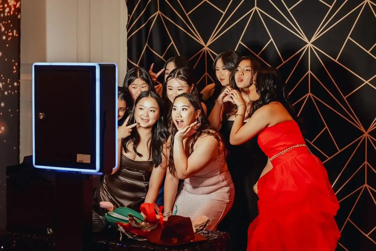 Photo booth hire Berwick party - guests laughing with festive props and instant photo prints by Pixel Booth Melbourne