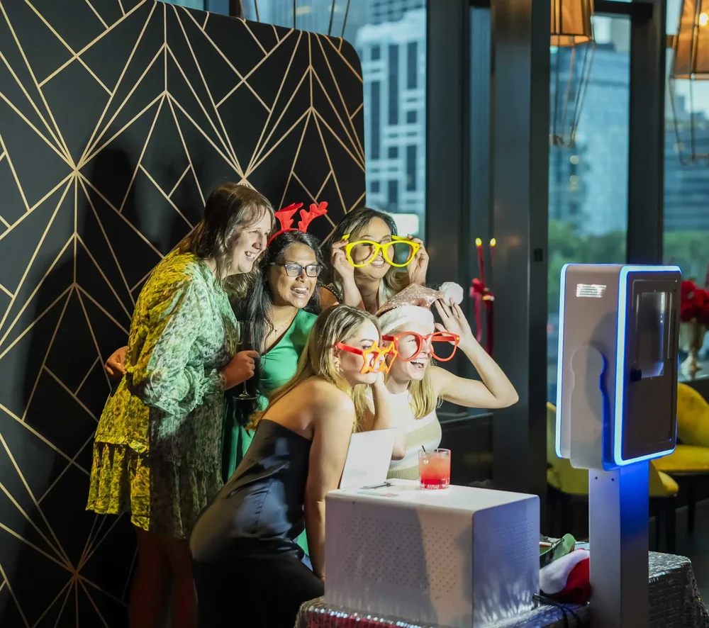 Guests posing with colourful props at an open-air photo booth available for Dandenong events