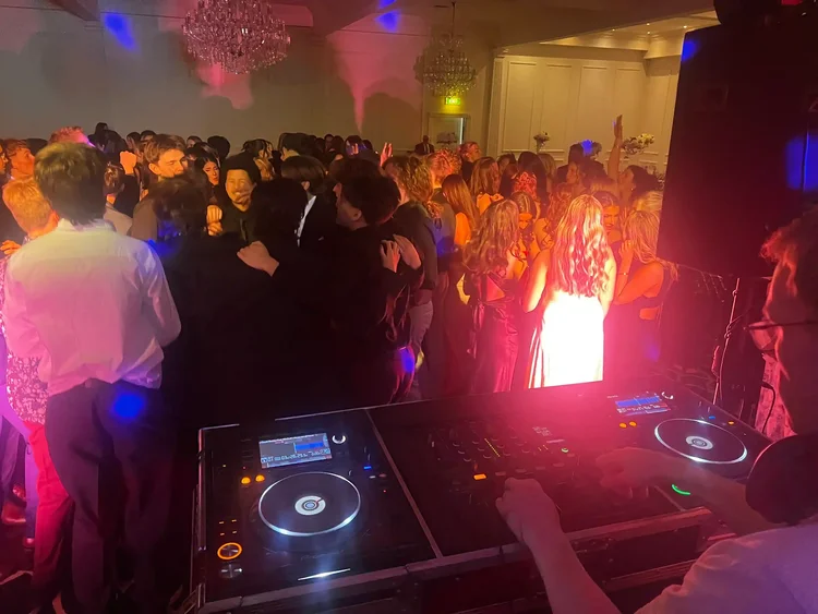 DJ hire Dandenong setup at a school graduation with guests dancing