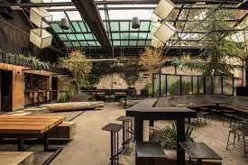Industrial-style bar space at Howler Brunswick with open roof and timber seating — modern Melbourne venue for photo booth hire and events by Pixel Booth.