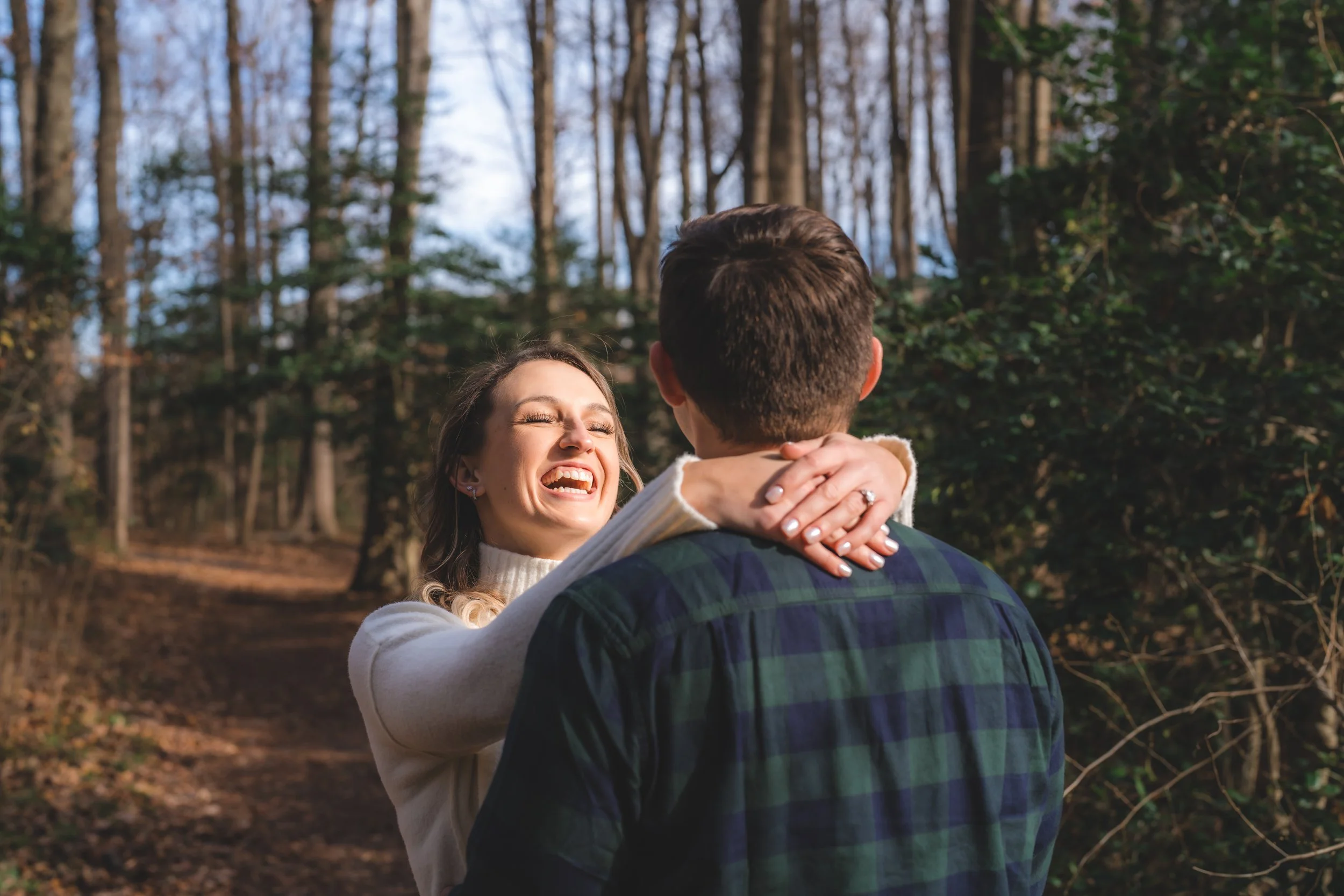 Engaged couple laughing together during their session