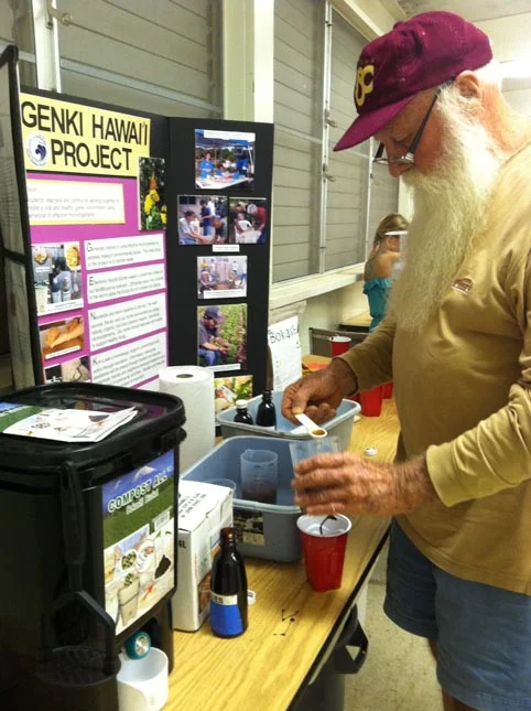 Oahu Master Gardener carefully measuring EM 1.