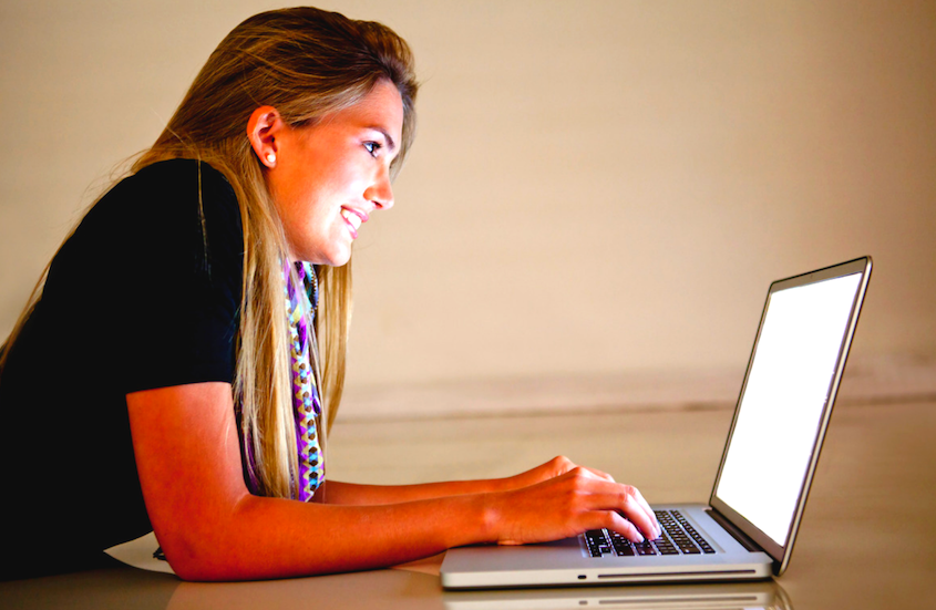 Girl smiling on cimputer.png