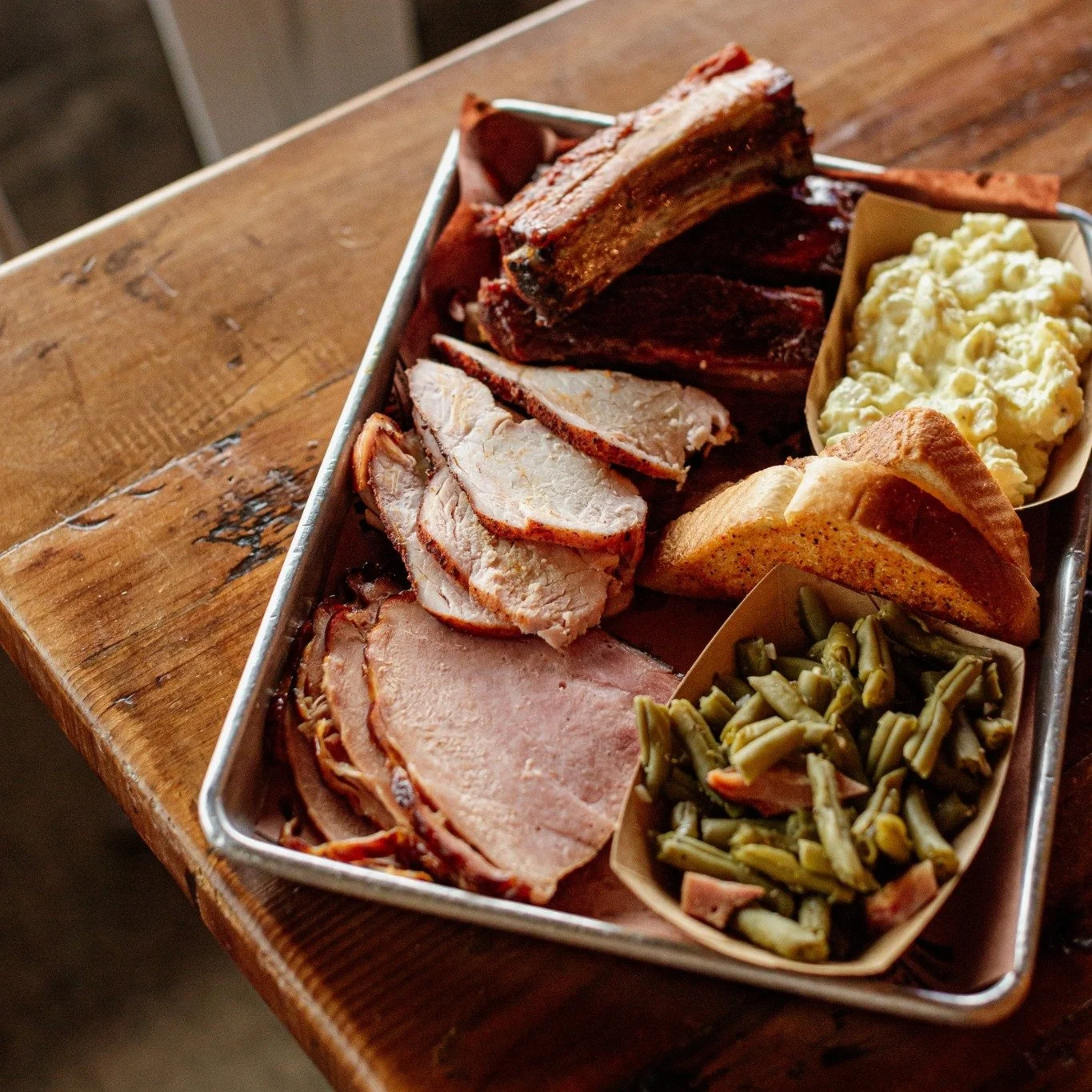 Pick three: ribs, ham, turkey, burnt ends, pulled chicken, brisket, pulled pork, sausage. We&rsquo;ll slap two sides on the plate and let you explain to your diet why you ghosted it. Whatever you choose, two sides come along for the party. 

We call 