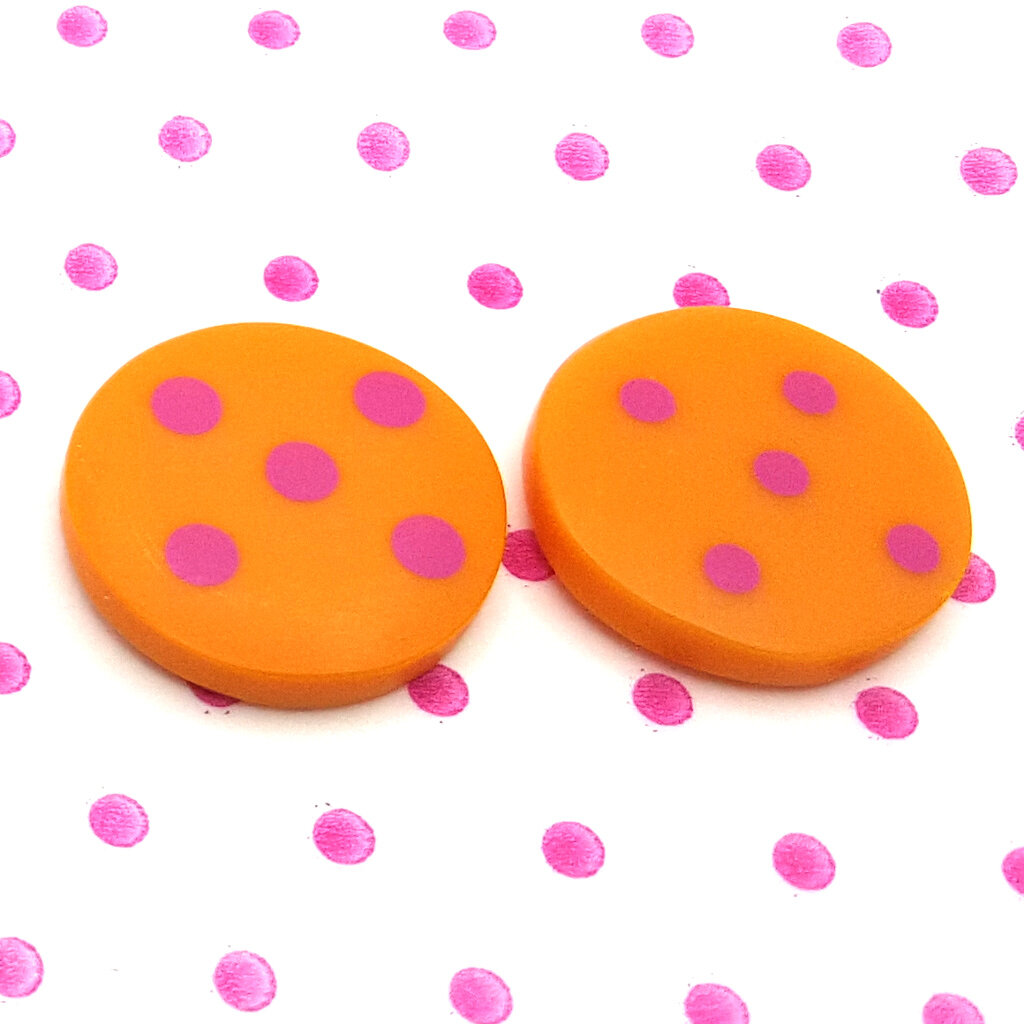 mismatch orange round resin studs with cerise pink spots and dots pattern inlayed.