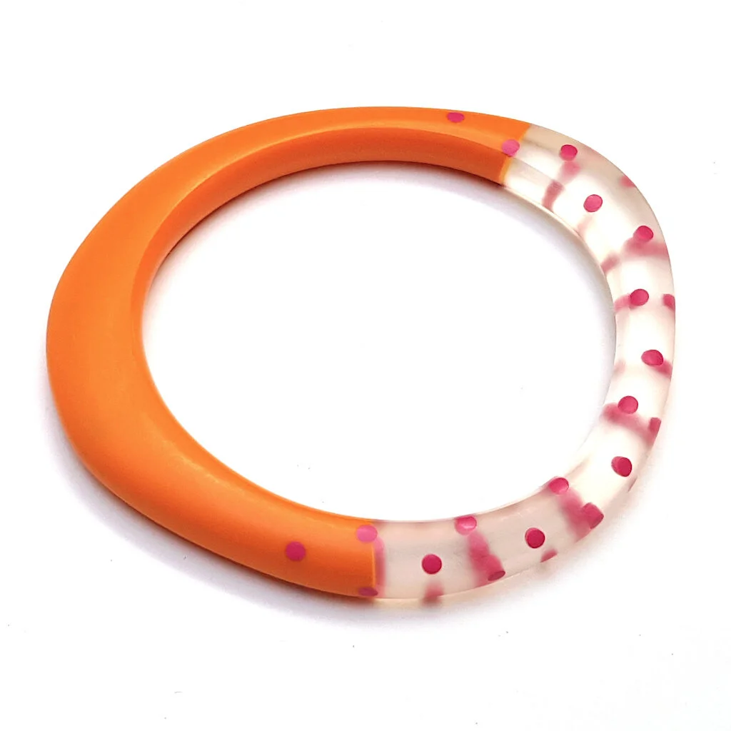 Wangle bangle-orange/clear cut out with cerise spots