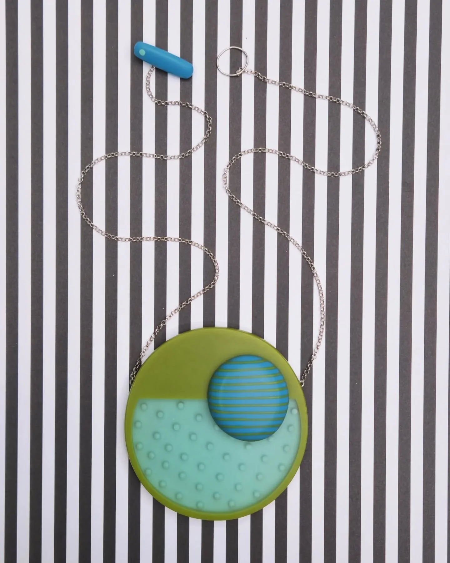 S T A T E M E N T ! ! !

Looking for something colourful, unique and fun to  pop your outfit?

This big pendant is a bit WOW!

Using my reverse dot pattern technique the spots have a 3D effect in the resin with the green edge for that pop of colour a