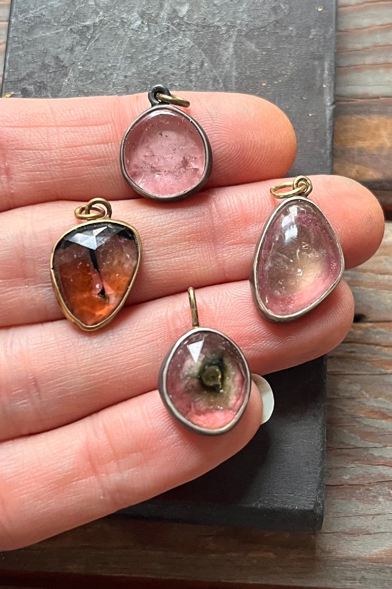 pink_tourmaline_charms_held.jpg