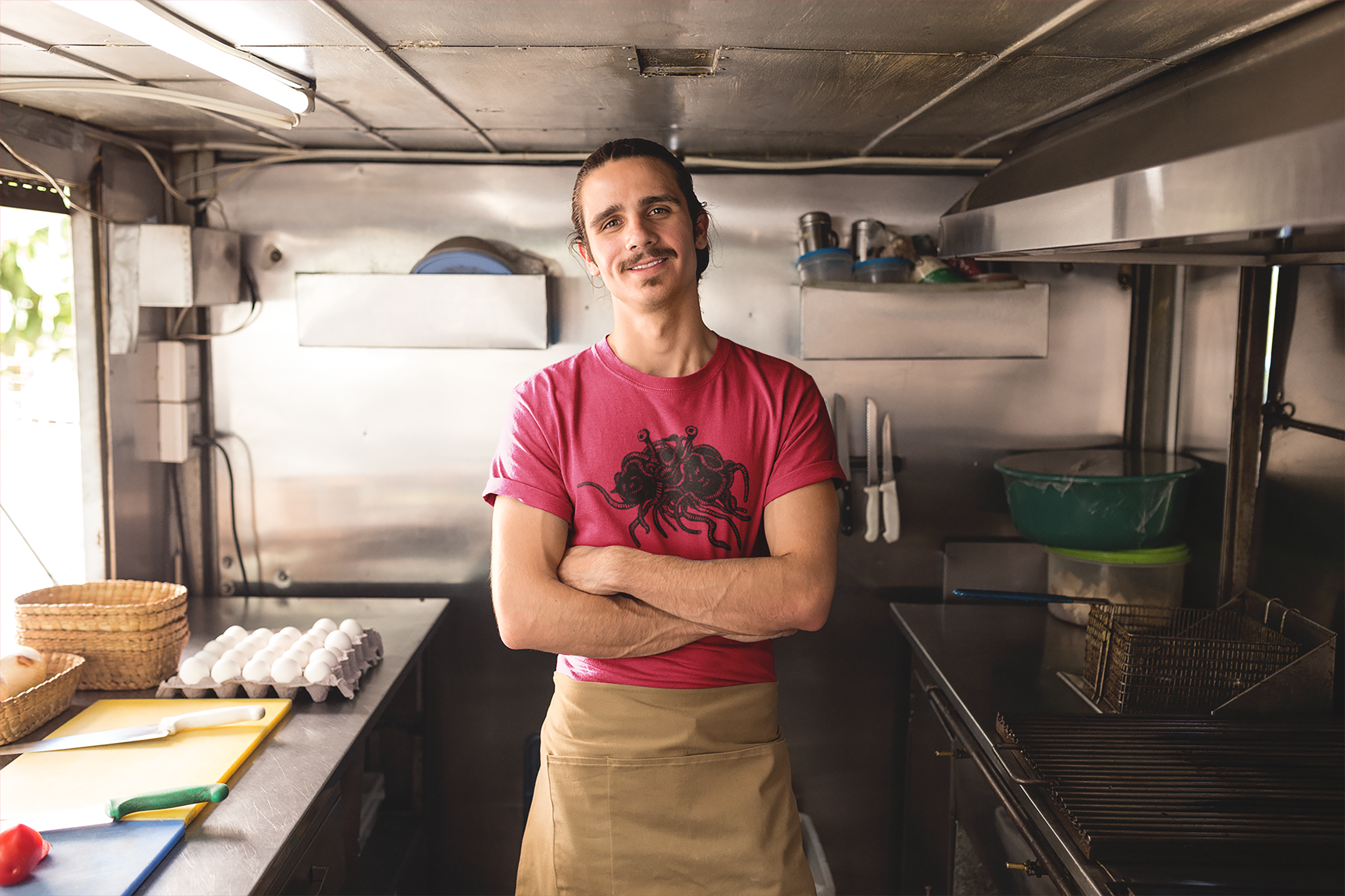 cook-wearing-a-t-shirt-mockup-and-an-apron-in-his-food-truck-a20301 copy.png