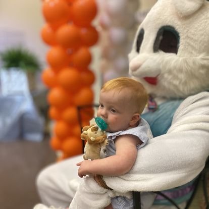 kid being held by the easter bunny 