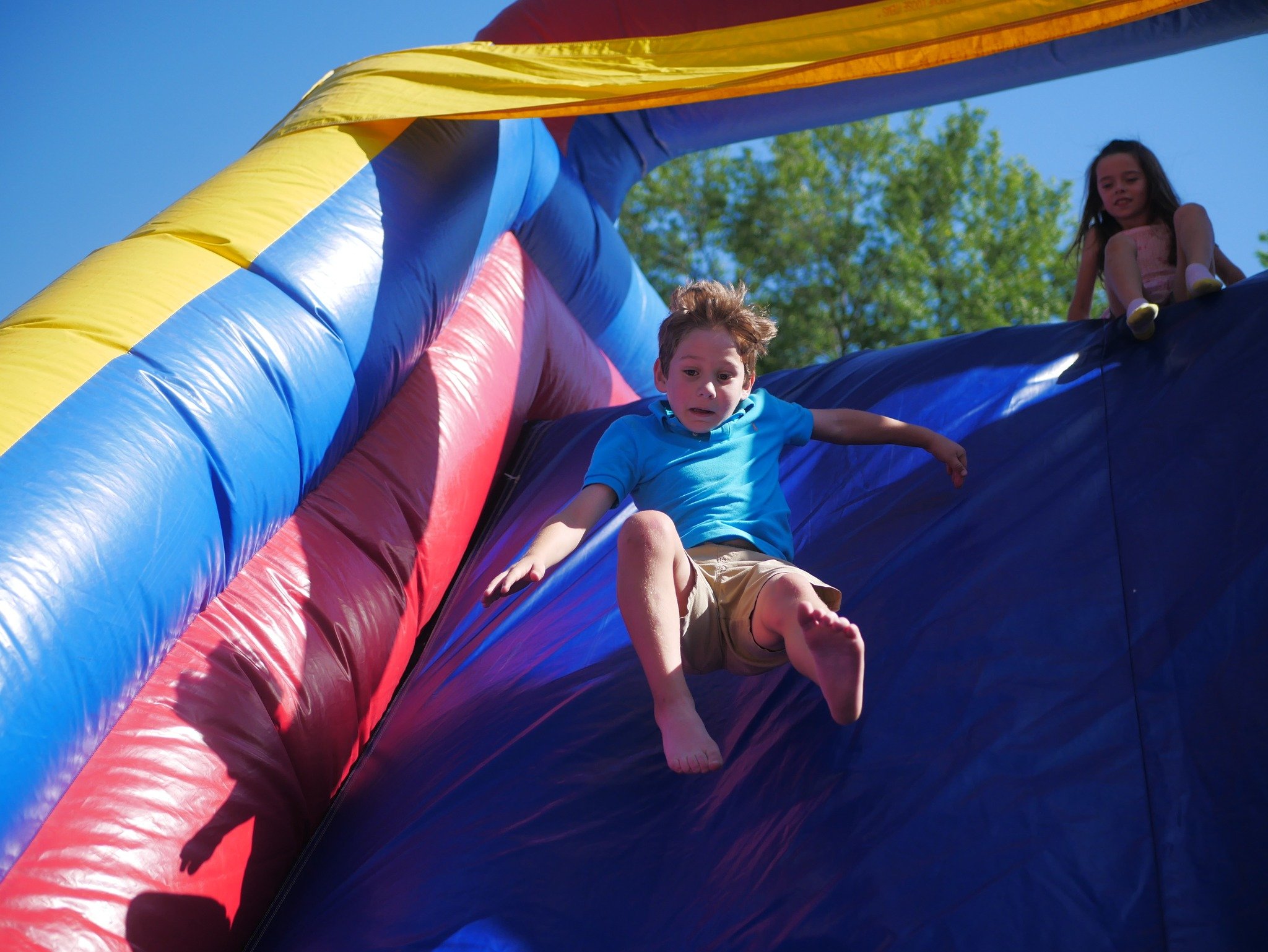 kids coming down blow up slide