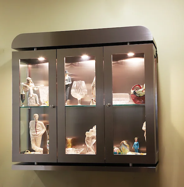 I designed and had my furniture maker create this lighted floating display cabinet in metal with framed glass doors and sides and thick shelves. This can be viewed from all angles. Metal accents were added for EXTRA WOW!