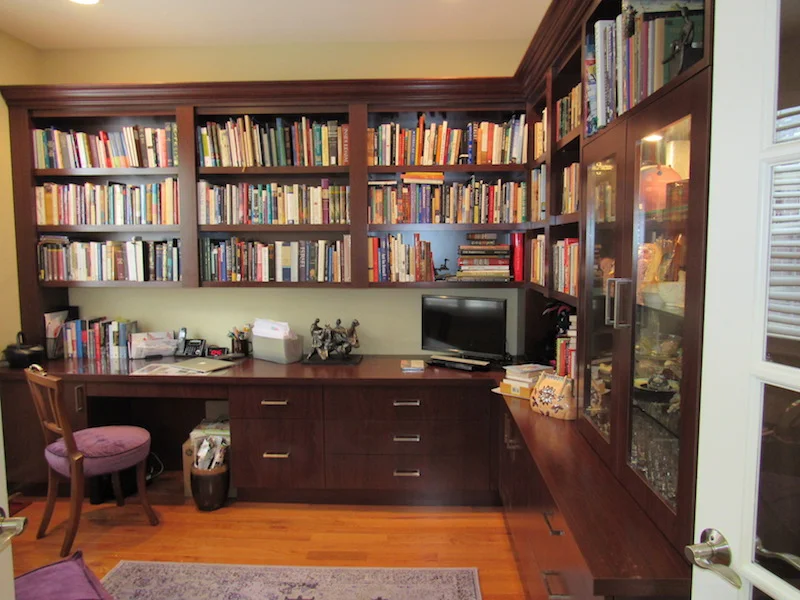 This home office has lighted under bookcase shelves with lots of storage. Most equipment is hidden on pull-outs with lots of hidden ports throughout. Lighted framed equipment display area for crystal objects is included.