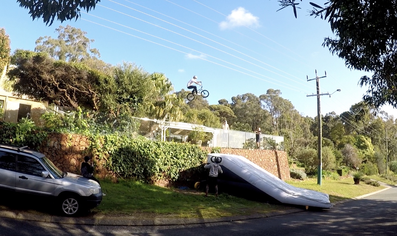Fast enough to make the gap but low enough to miss the powerlines! Pictured: DD AirBags NextStep BMX Lander