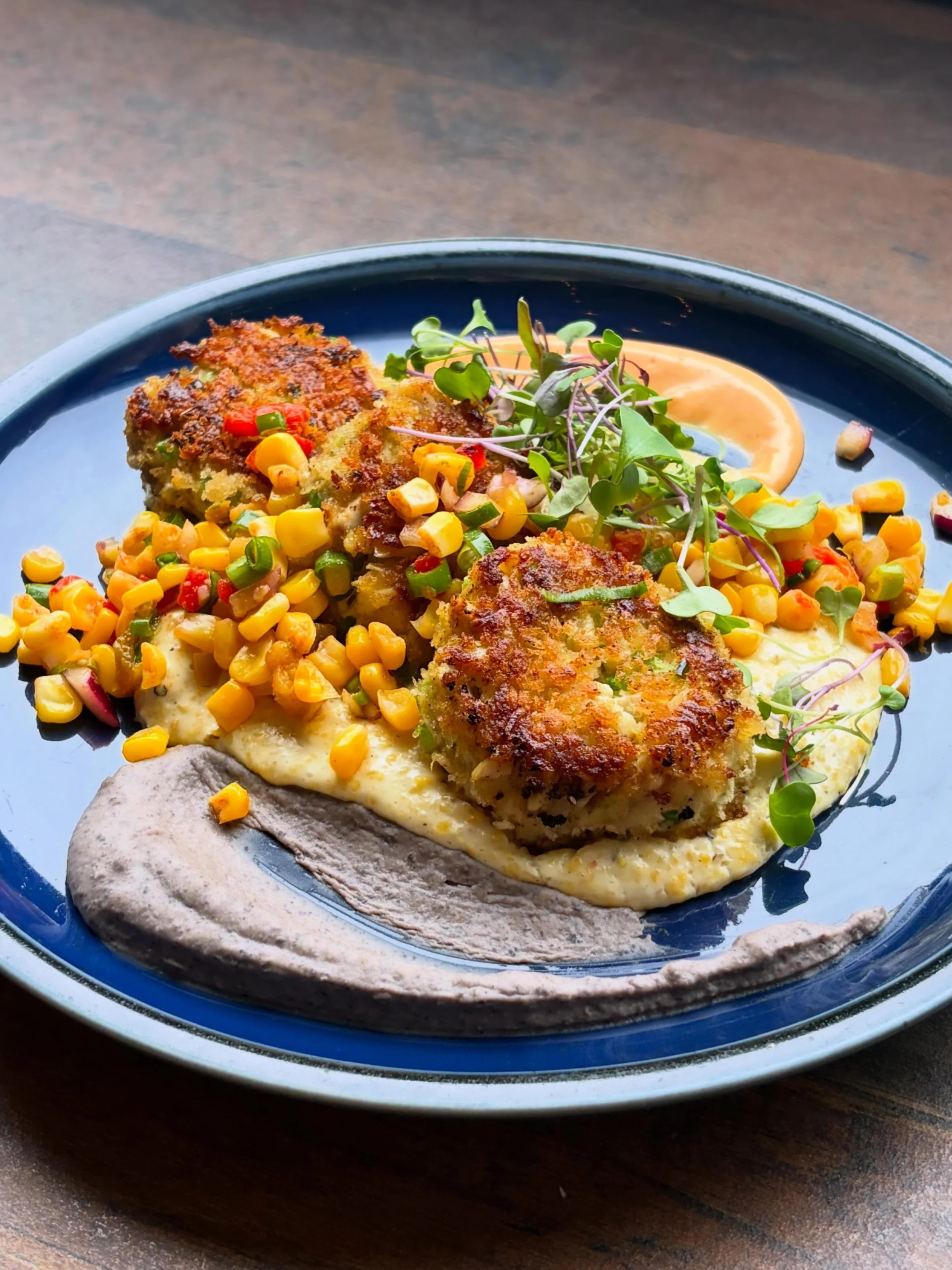 Jumbo lump blue crab cakes, goat cheese NC grits, corn &amp; roasted red pepper pico, black bean pur&eacute;e, &amp; Cholula aioli&mdash;

Reservations are available all day on Sundays. Come see us tomorrow for some Bloody Marys on the covered patio!