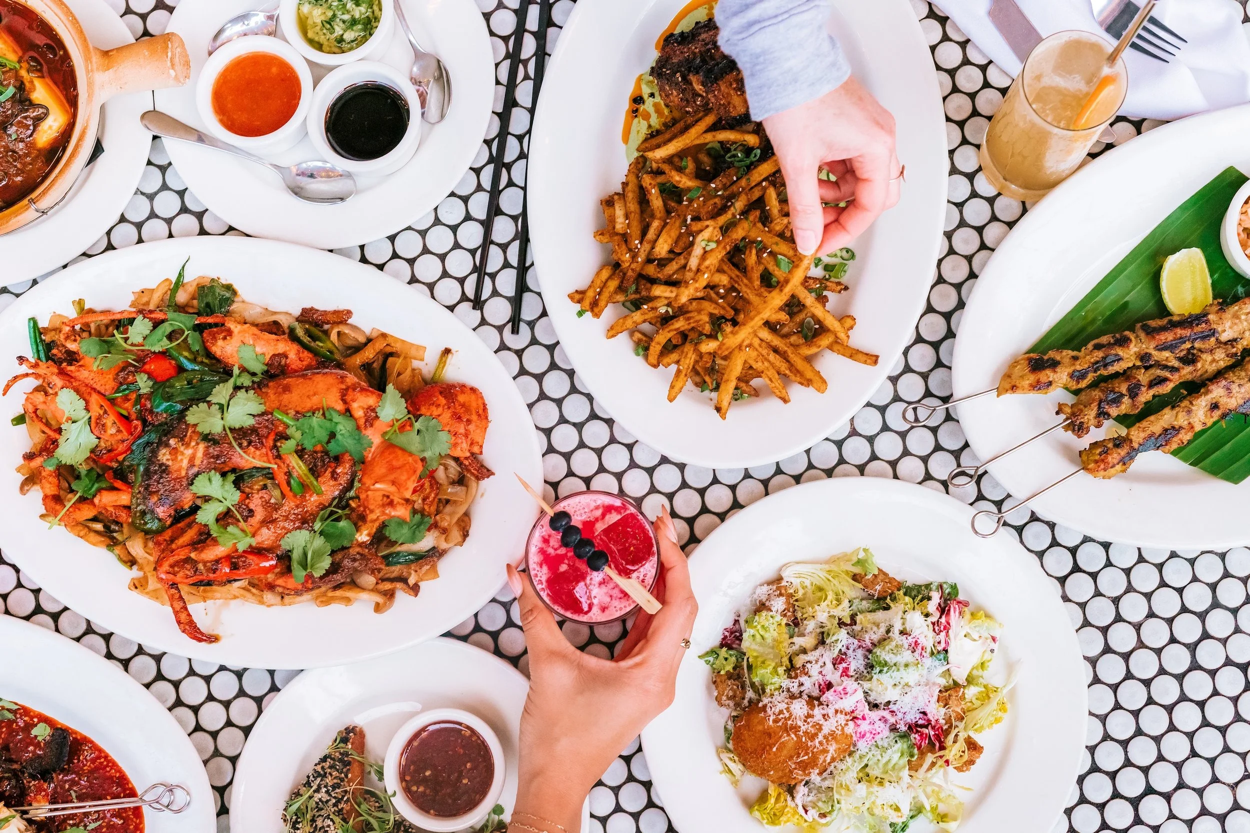 Variety of Cassia Dishes with Hands