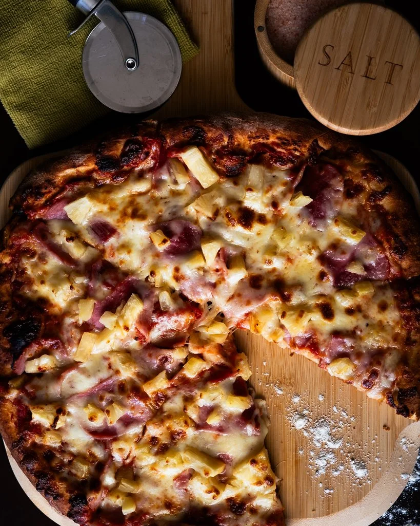 Top down photo of pizza on pizza lift