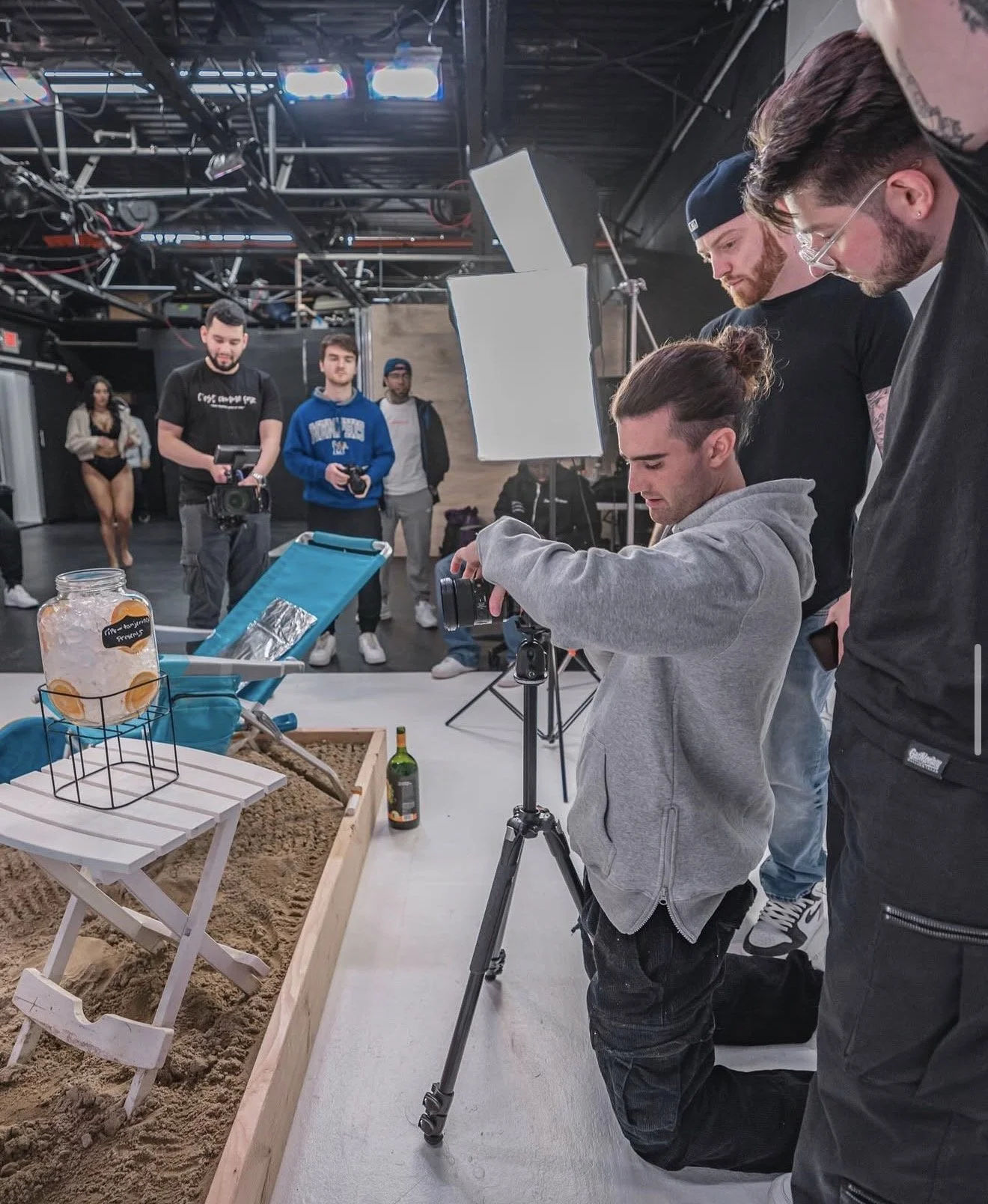 image of dom "tanj" bruno, nick sheehan, and nic violets on set at so–ripe studios for dave east's music video for "living single."