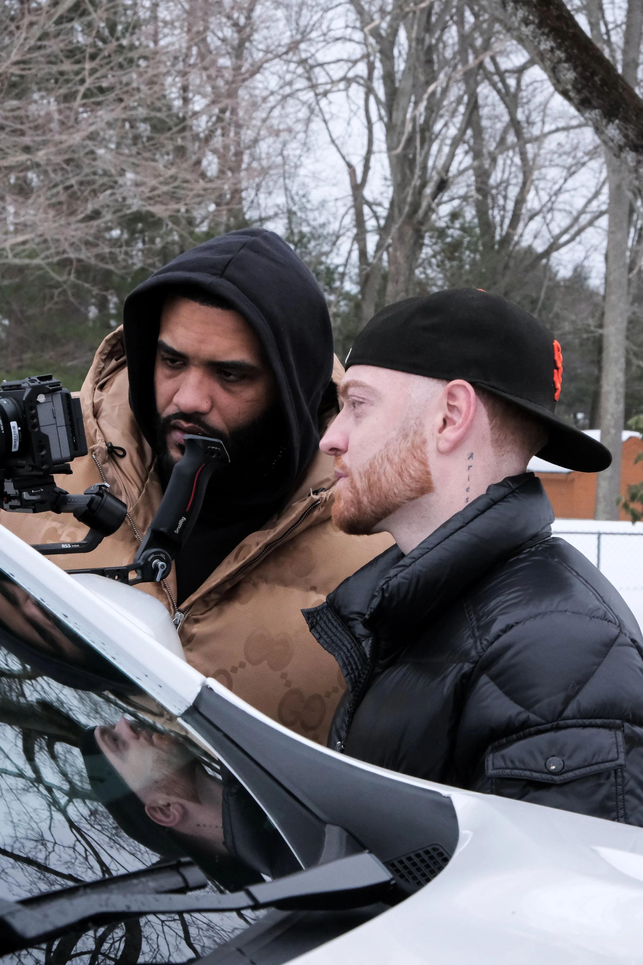 Joyner Lucas and Tanj looking at camera footage