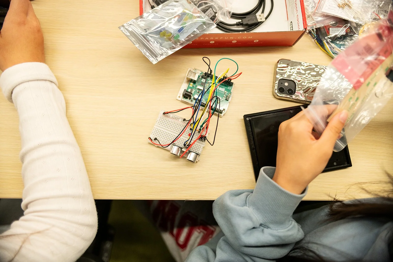 Lawrence Berkeley National Laboratory science in action. visiting scientists working with circut boards.