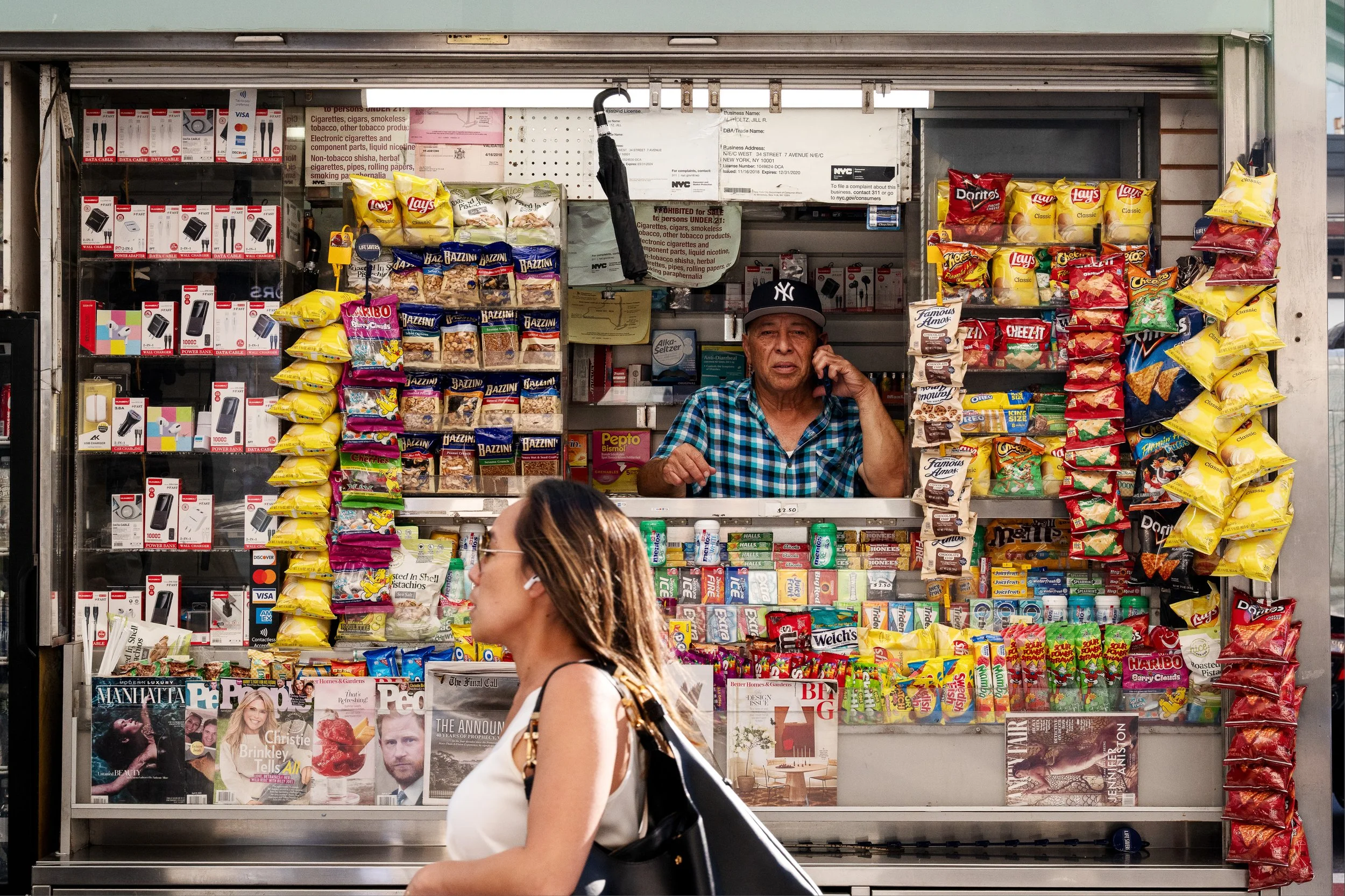 Street vendor on cell phone with female passerby