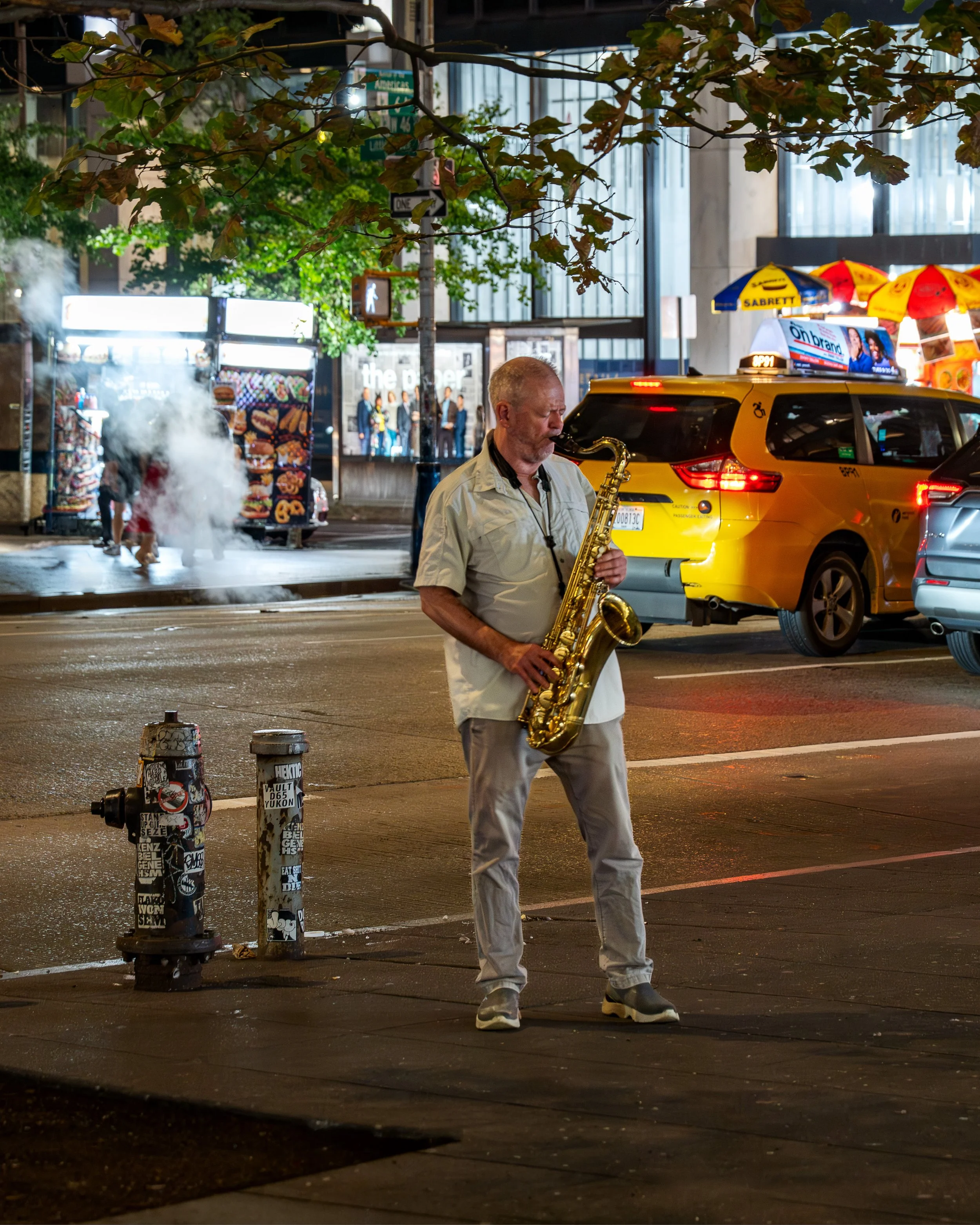 Saxophone player at midnight in New York Theater District