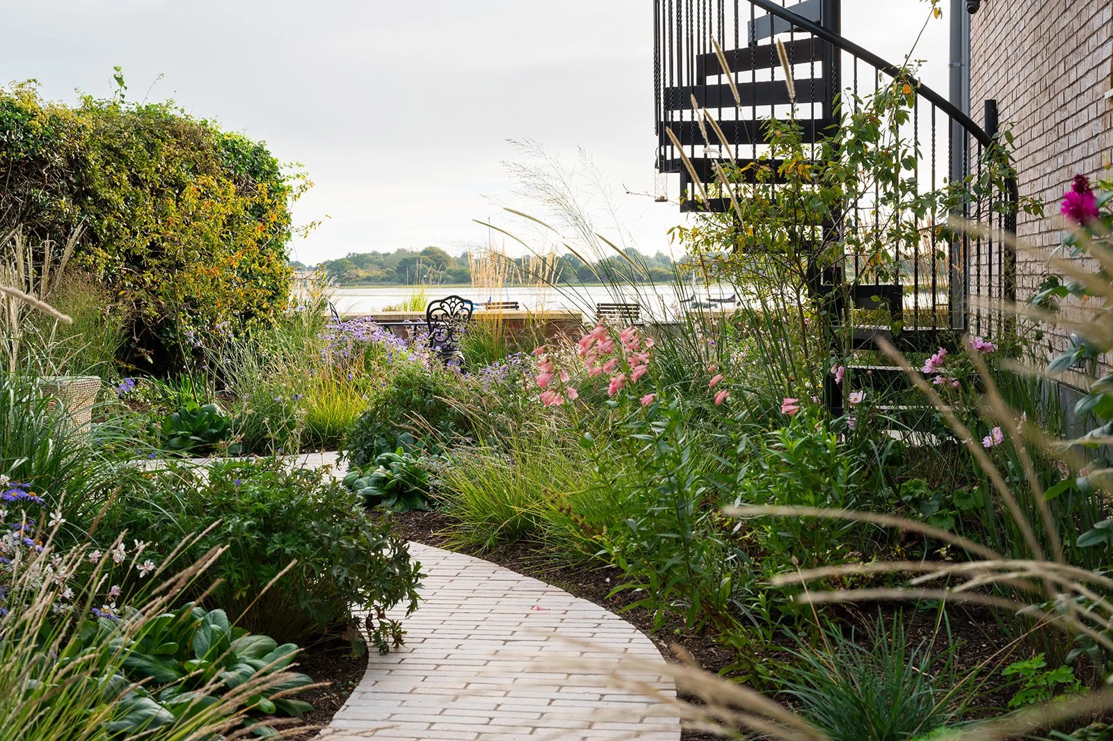 Contemporary Riverside Garden Design - Seating amongst the bedding