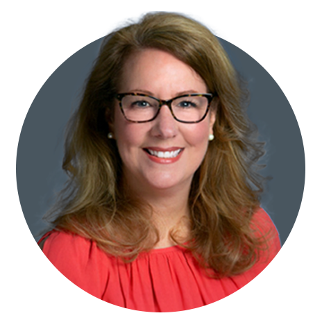 A woman with shoulder-length blond hair, wearing black glasses, pearl earrings, and a red top, smiling against a gray and blue background.