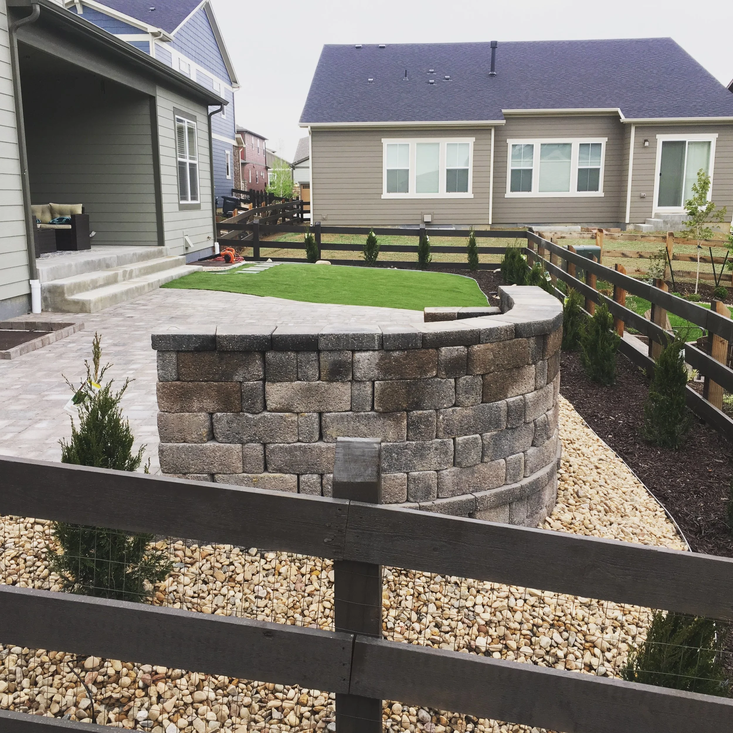 Small patio paver patio with wall and fence