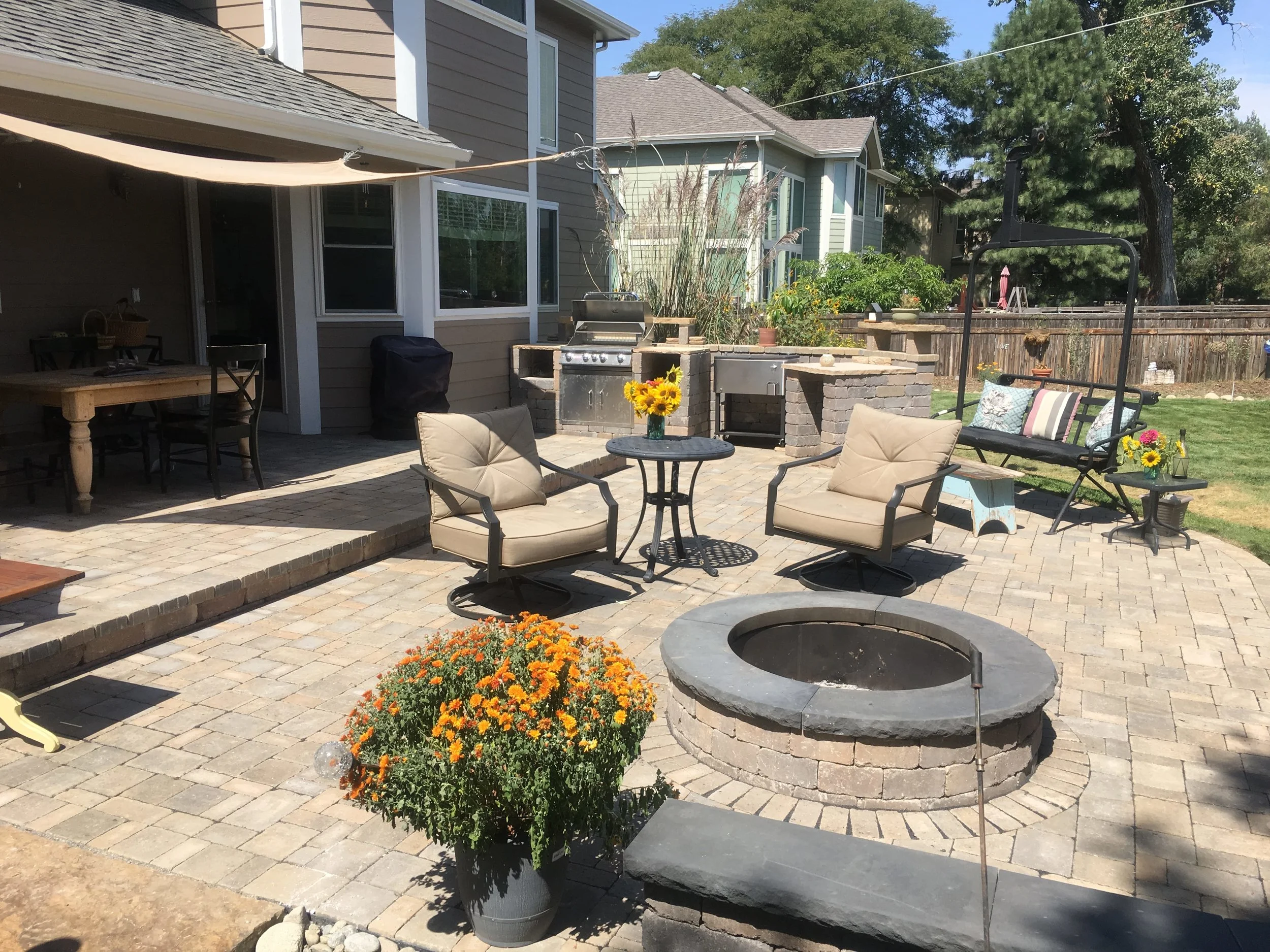 Large paver patio with firepit and seating