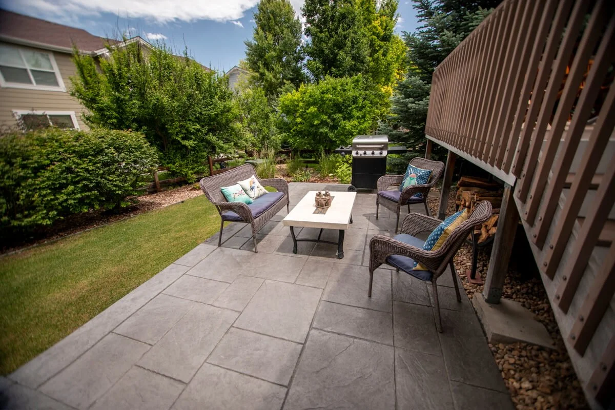 Second tier of patio with seating and grill