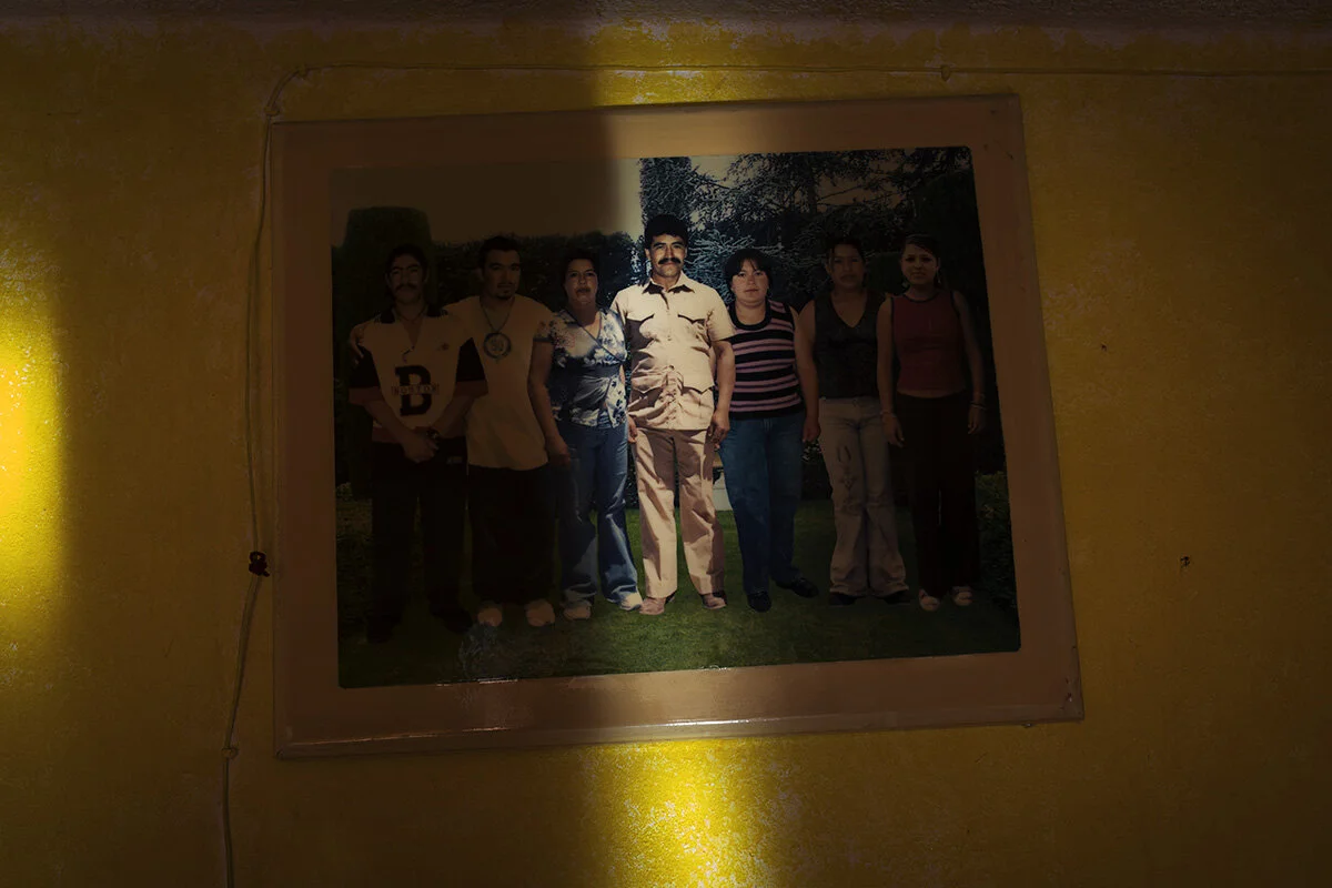 A family portrait that has been photoshopped together shows Blanca Isla Perez (third left) and Artemio Rodriquez (centre) with their five children. It hangs in the middle of Perez’s living room wall.