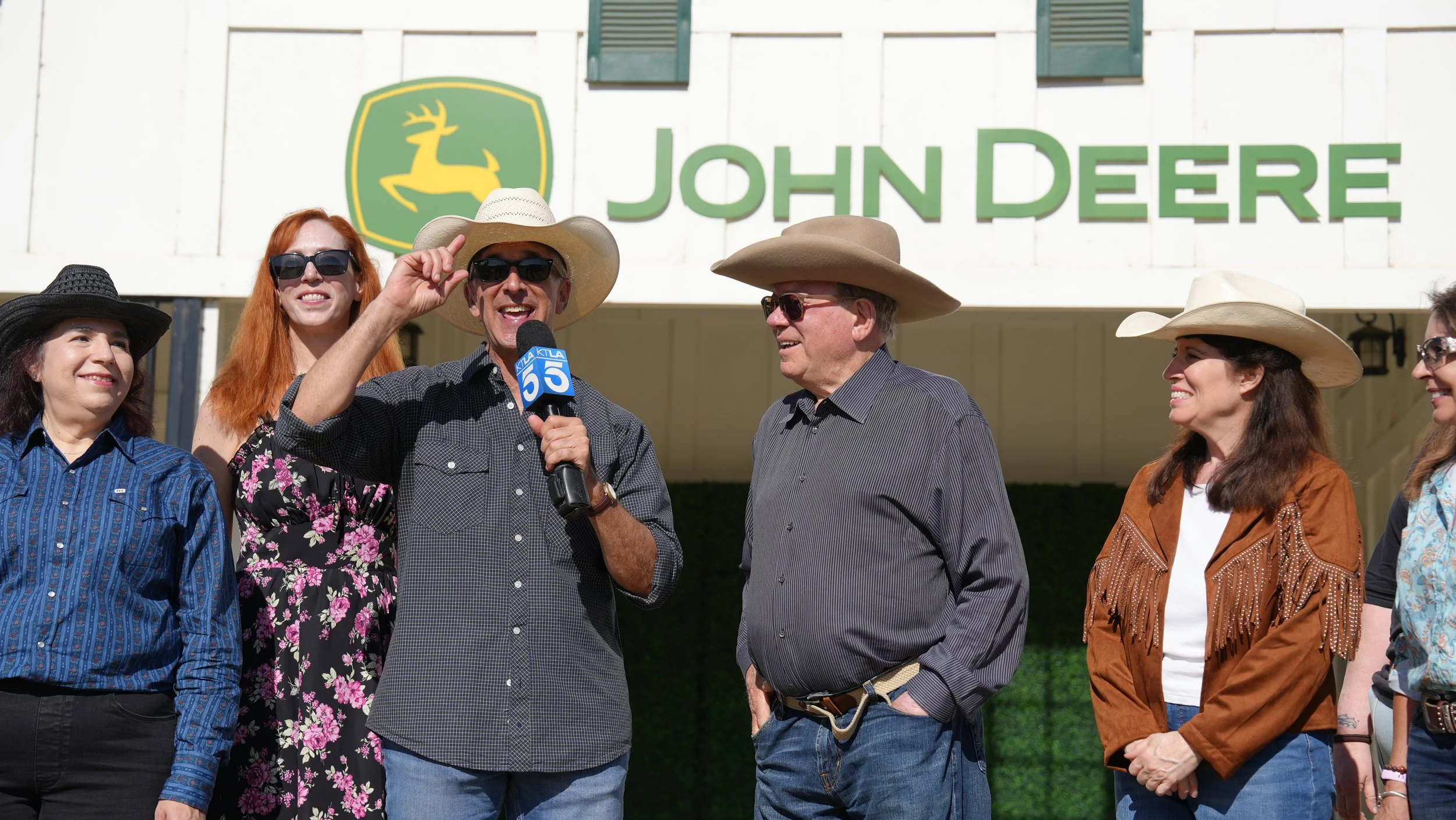 Scott "Movie" Mantz, William Shatner, and a few of his fans smile for the KTLA news cameras while standing in front of the John Deere Barn at the Los Angeles Equestrian Center.