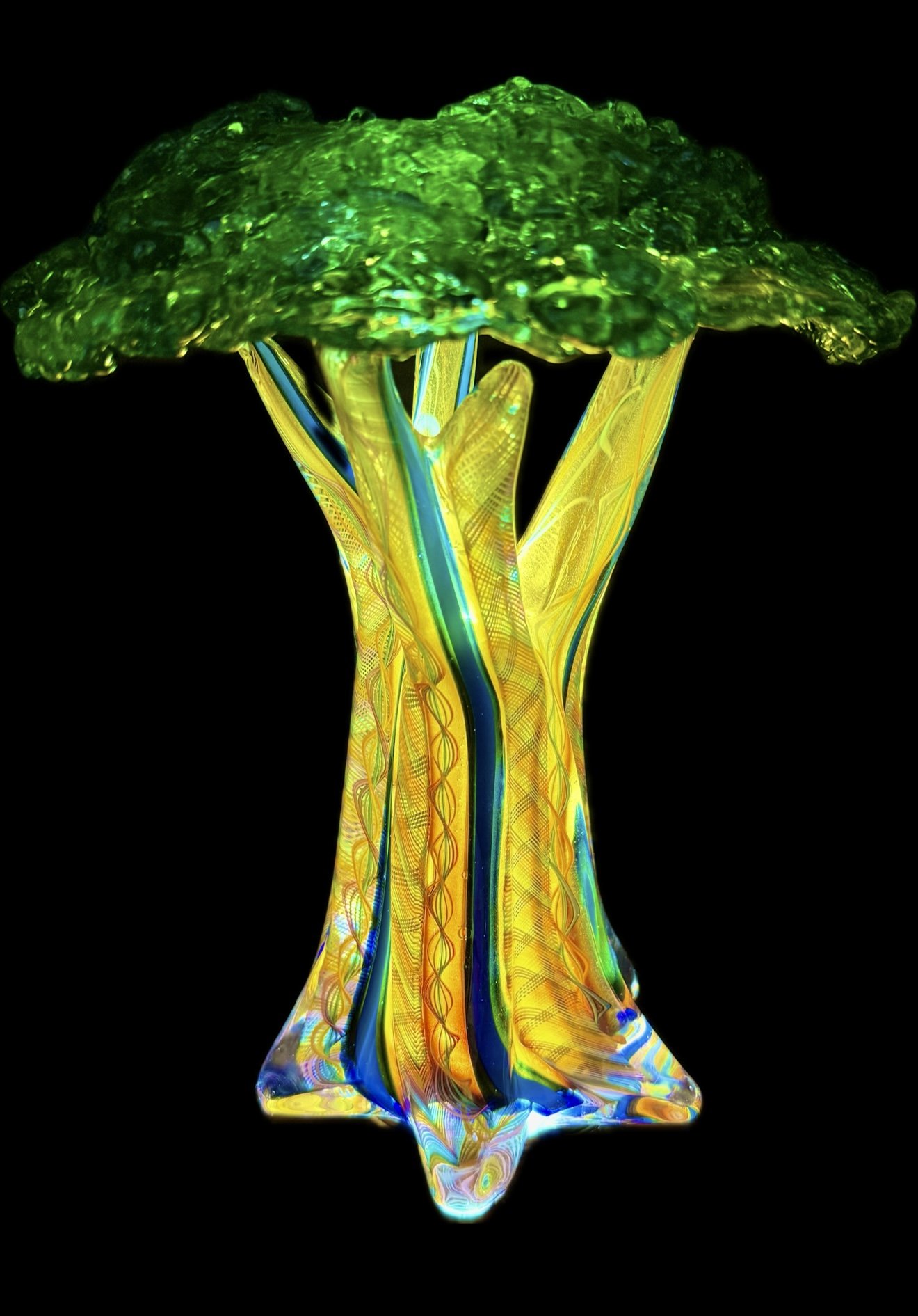 Handcrafted blown glass tree sculpture in vibrant green and yellow, made at Makai Glass art gallery in Maui