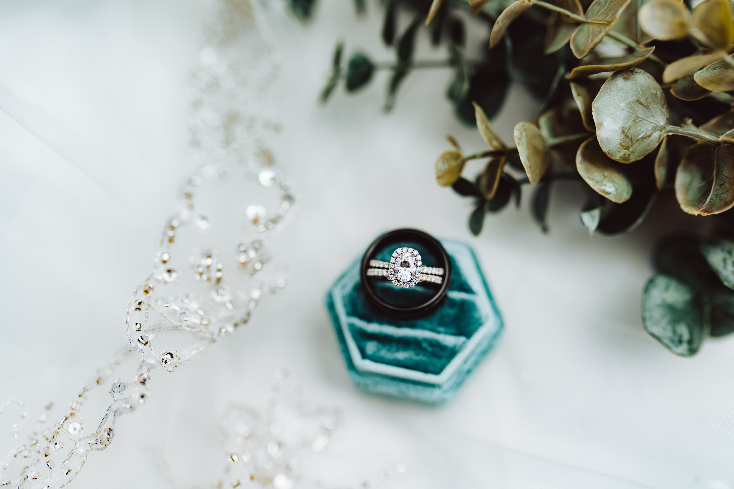 Detail photograph of wedding ring, veil and bride's bouquet