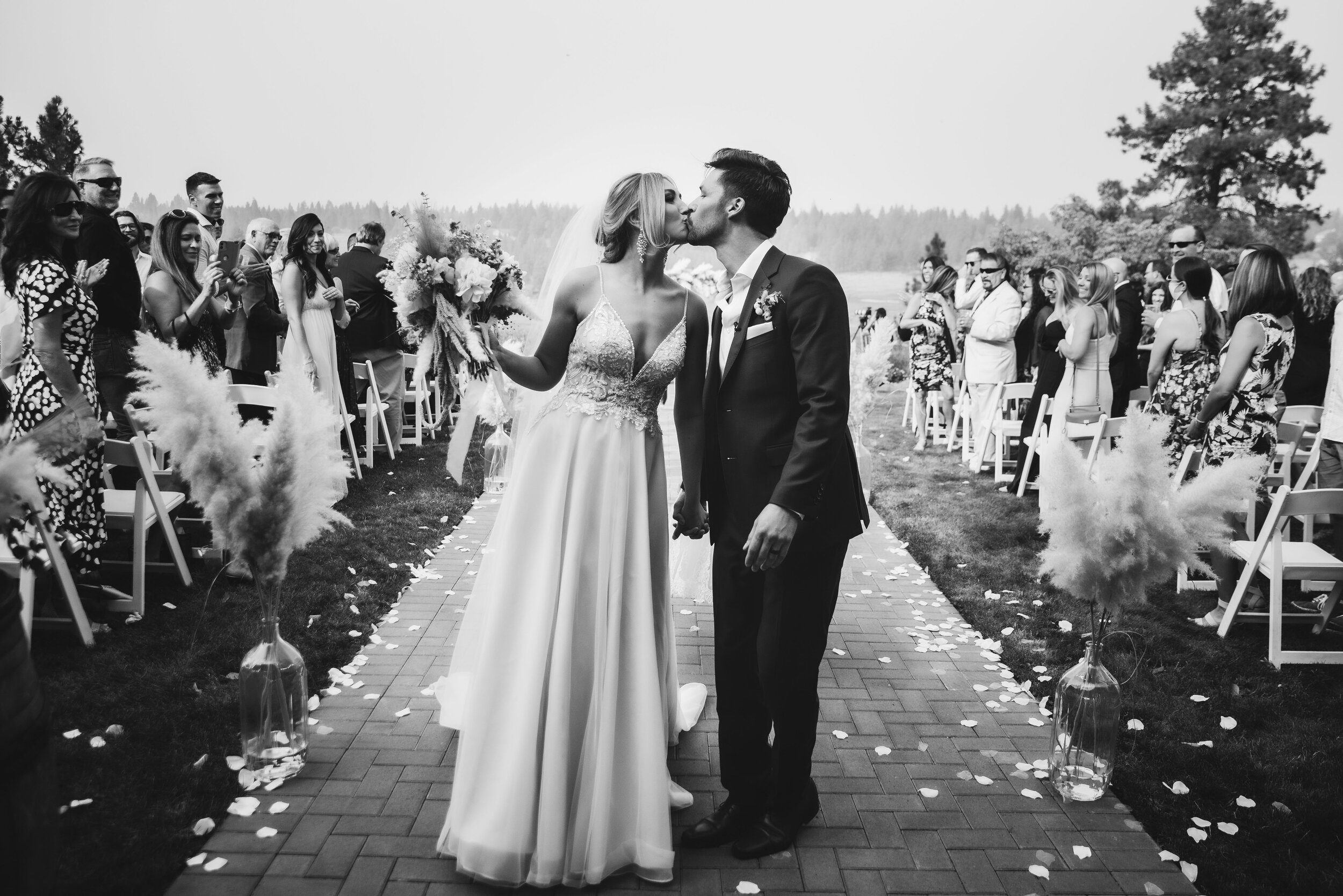 Bride and groom kiss walking back down aisle after wedding ceremony