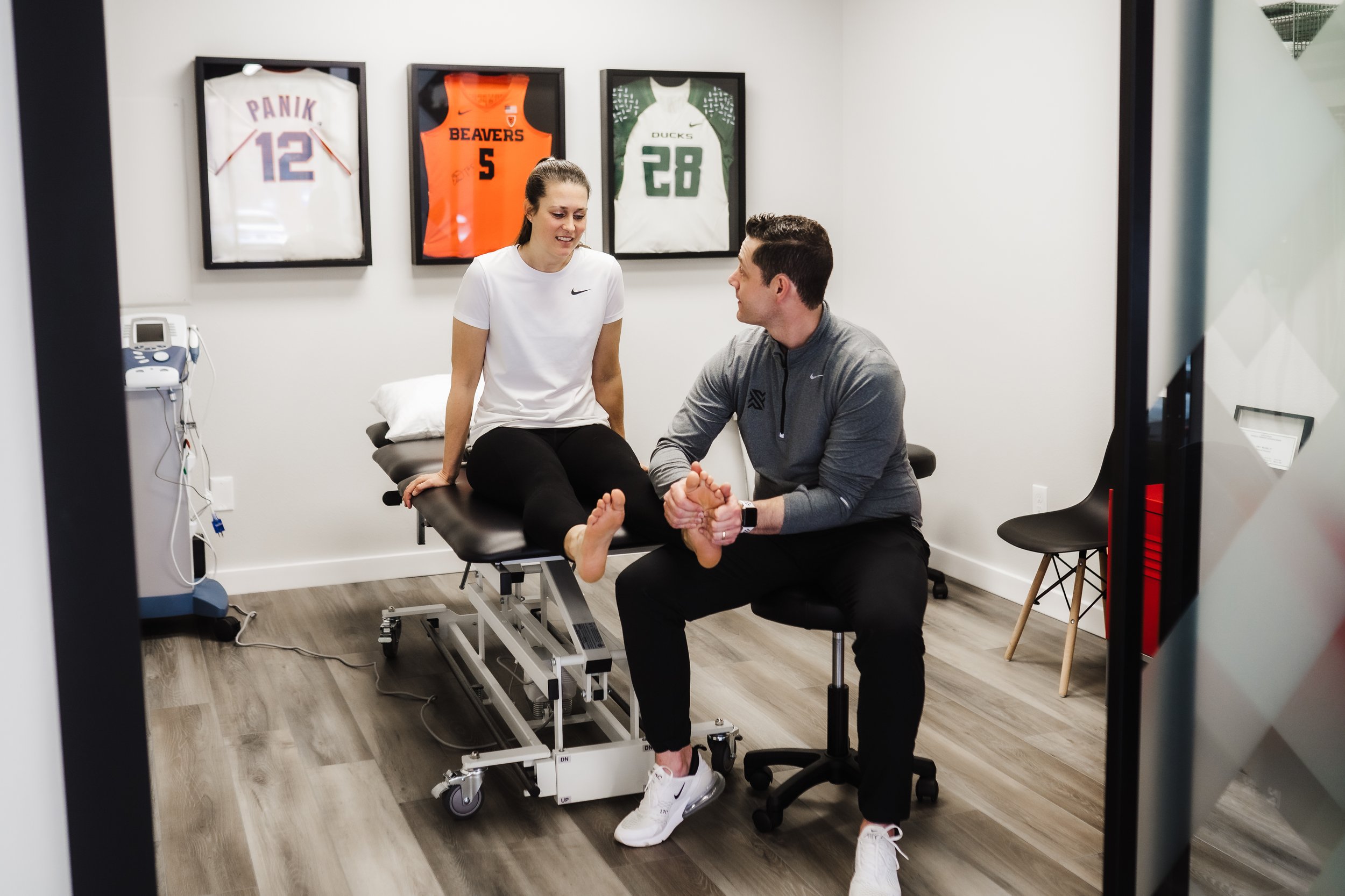 Physical therapist works on the foot of a runner