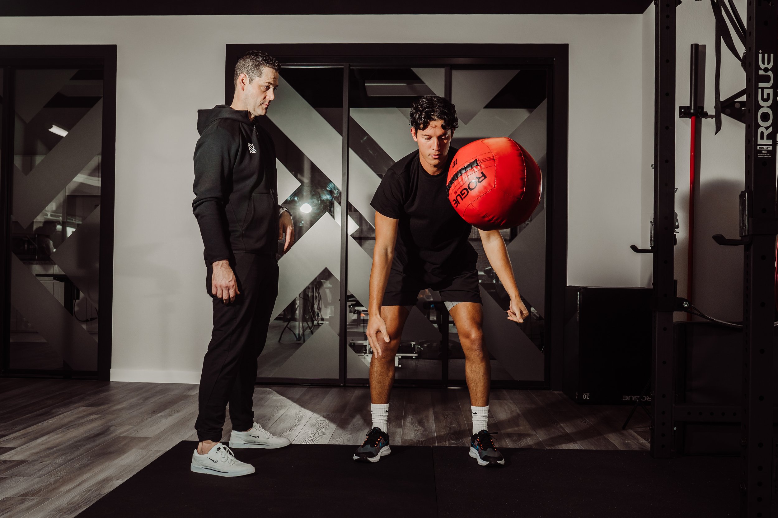 Athlete and therapist work on medicine ball throw drill