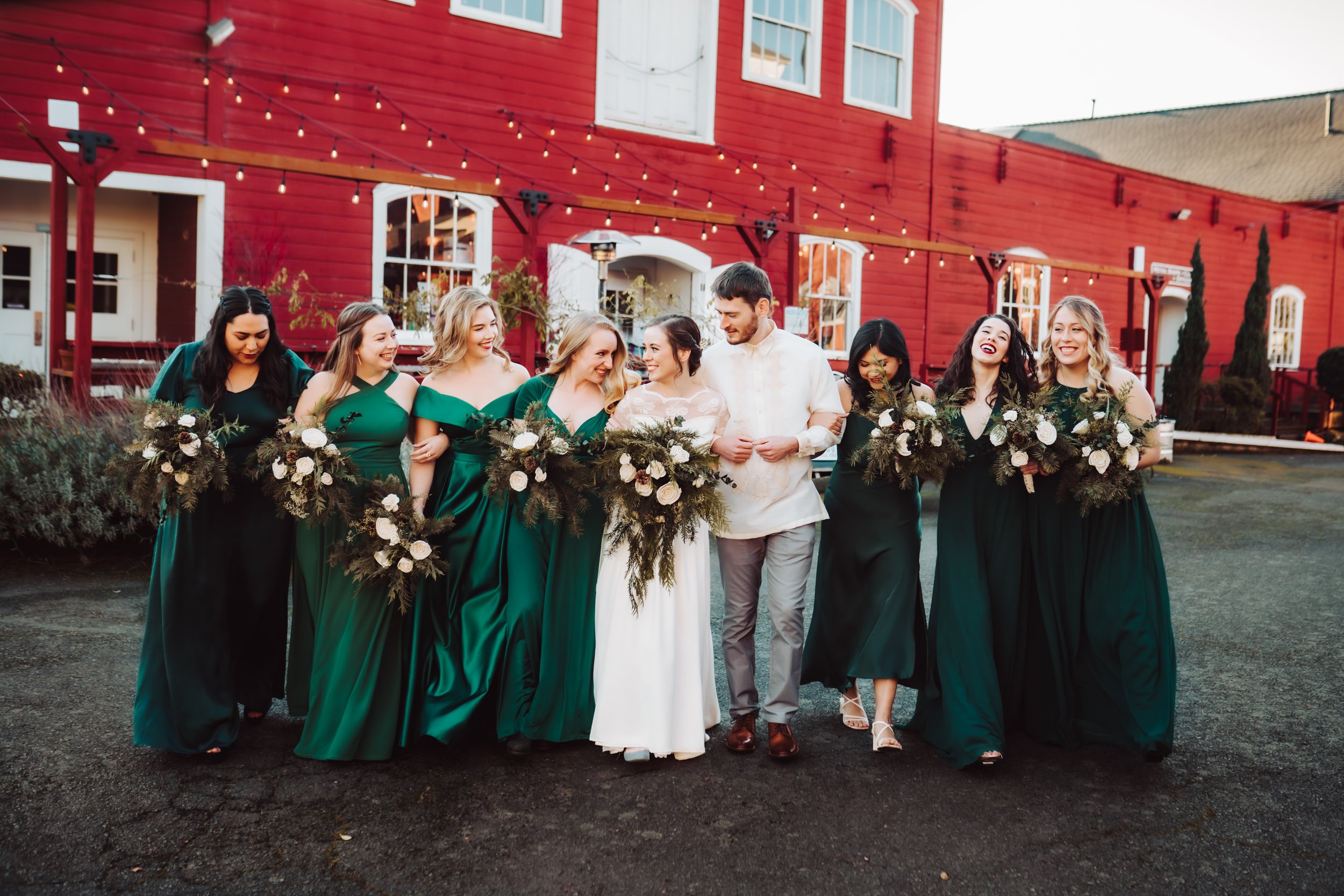 Bride and her wedding party smiling at each other