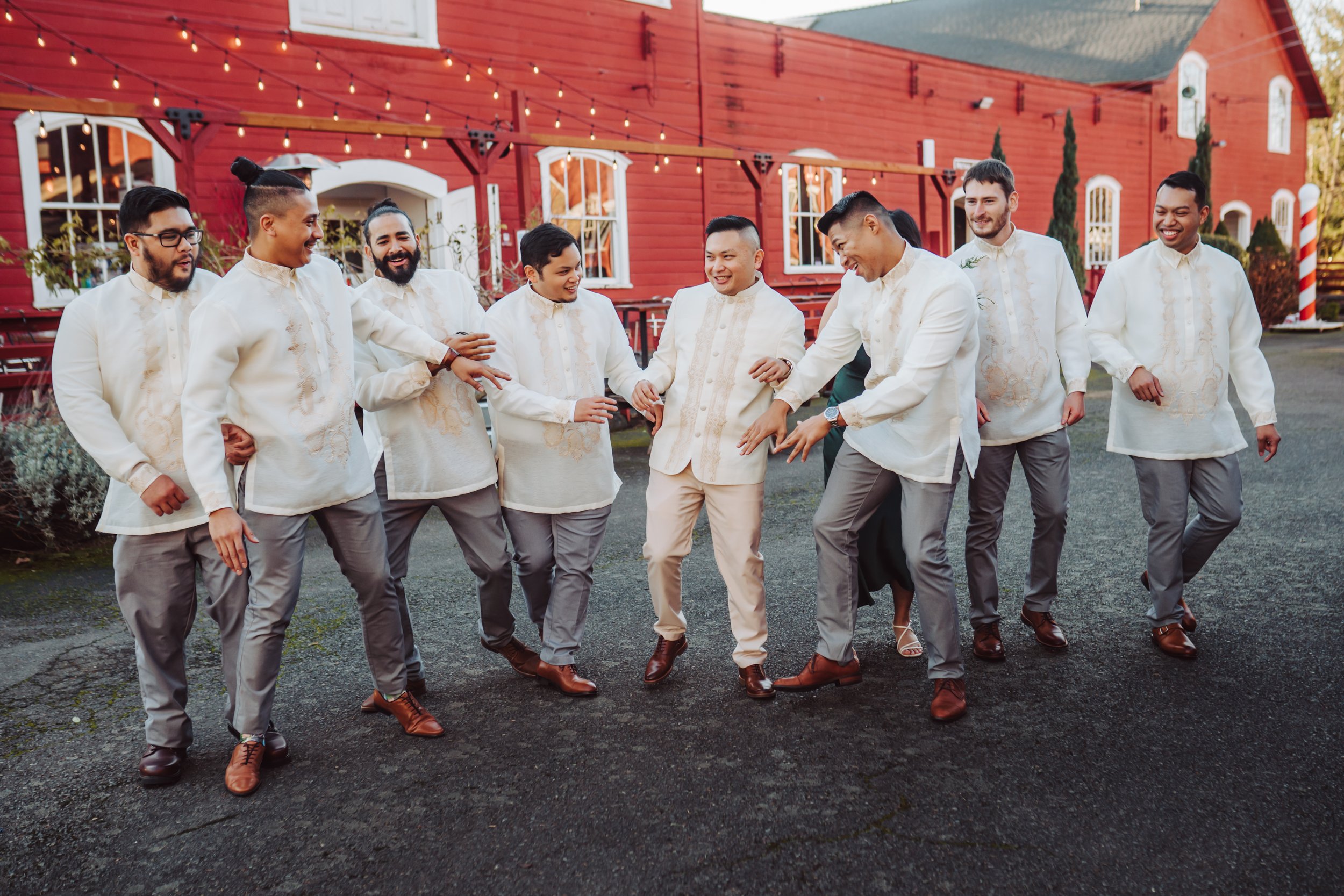 Groom with his wedding party laughing at each other