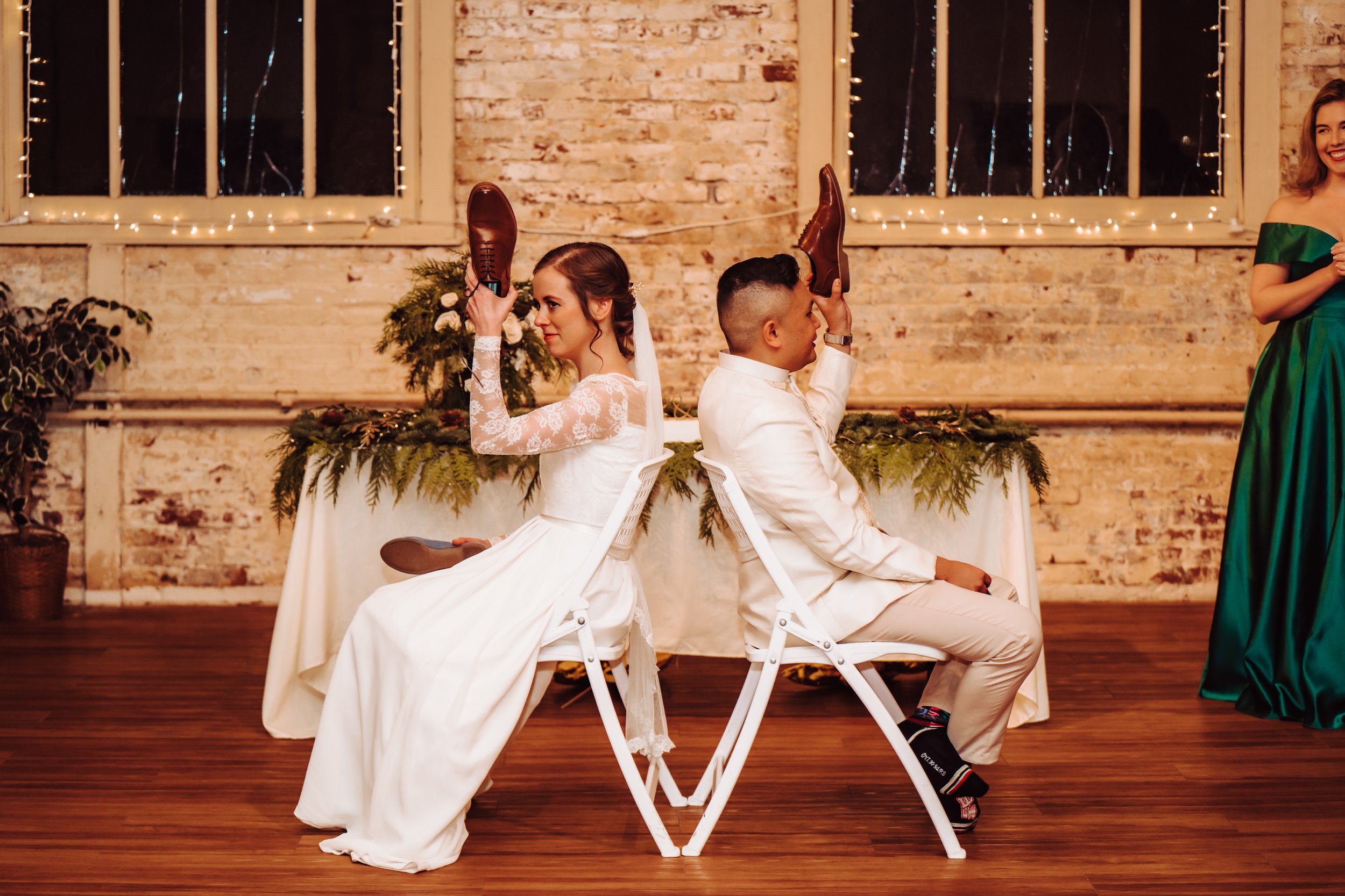 Bride and groom playing the shoe game at their reception