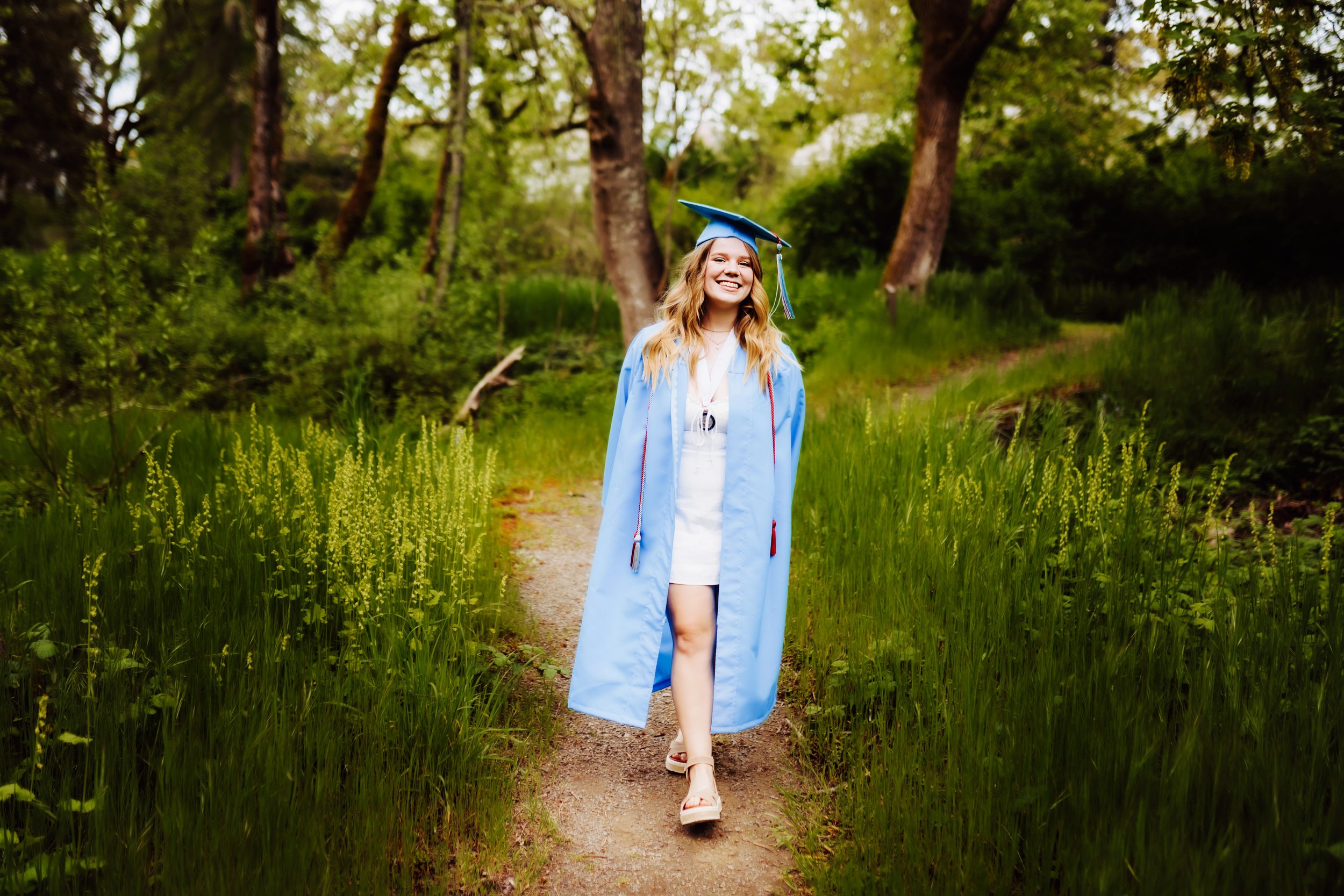 Graduation senior walking through forest