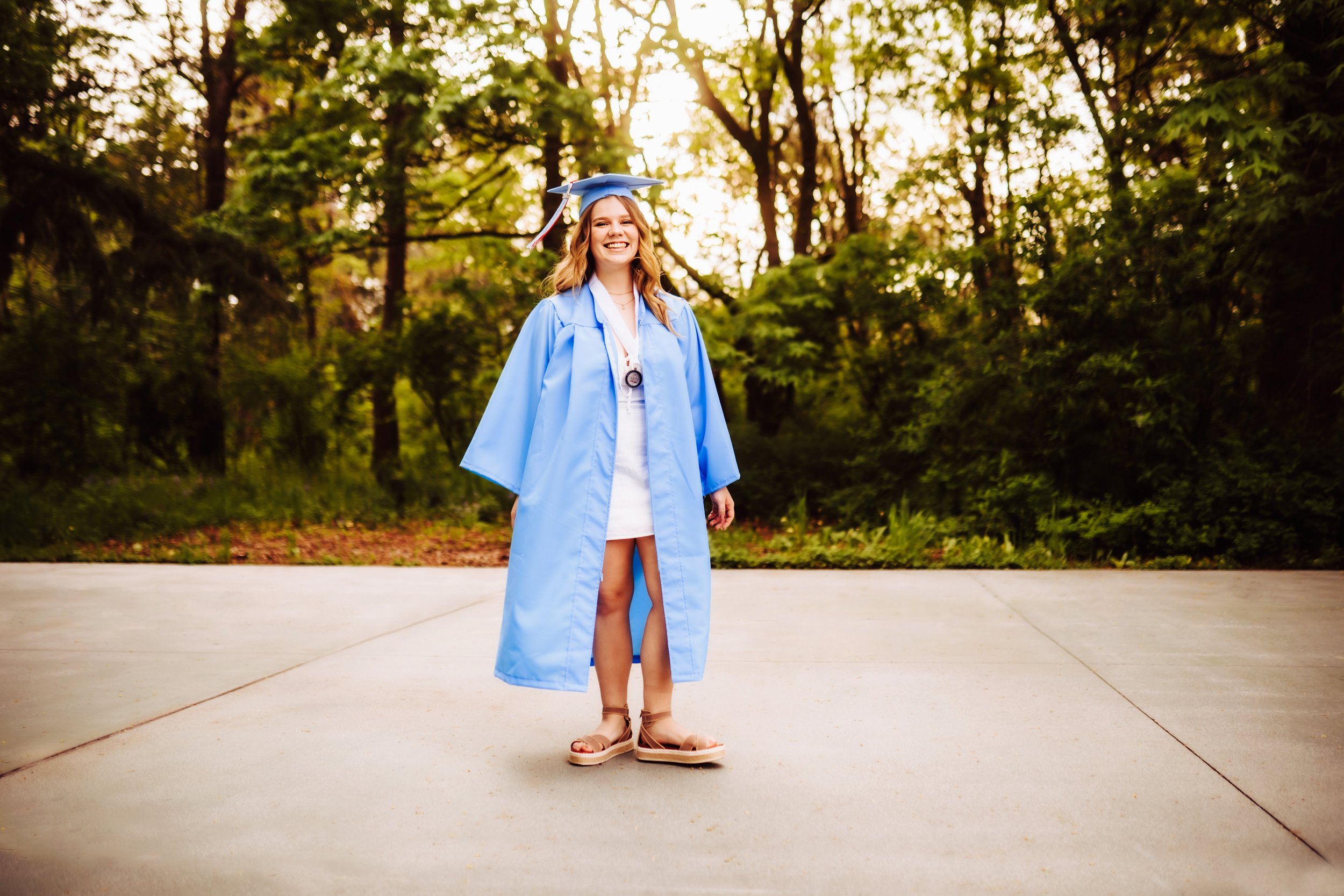 Graduating senior in blue gown standing
