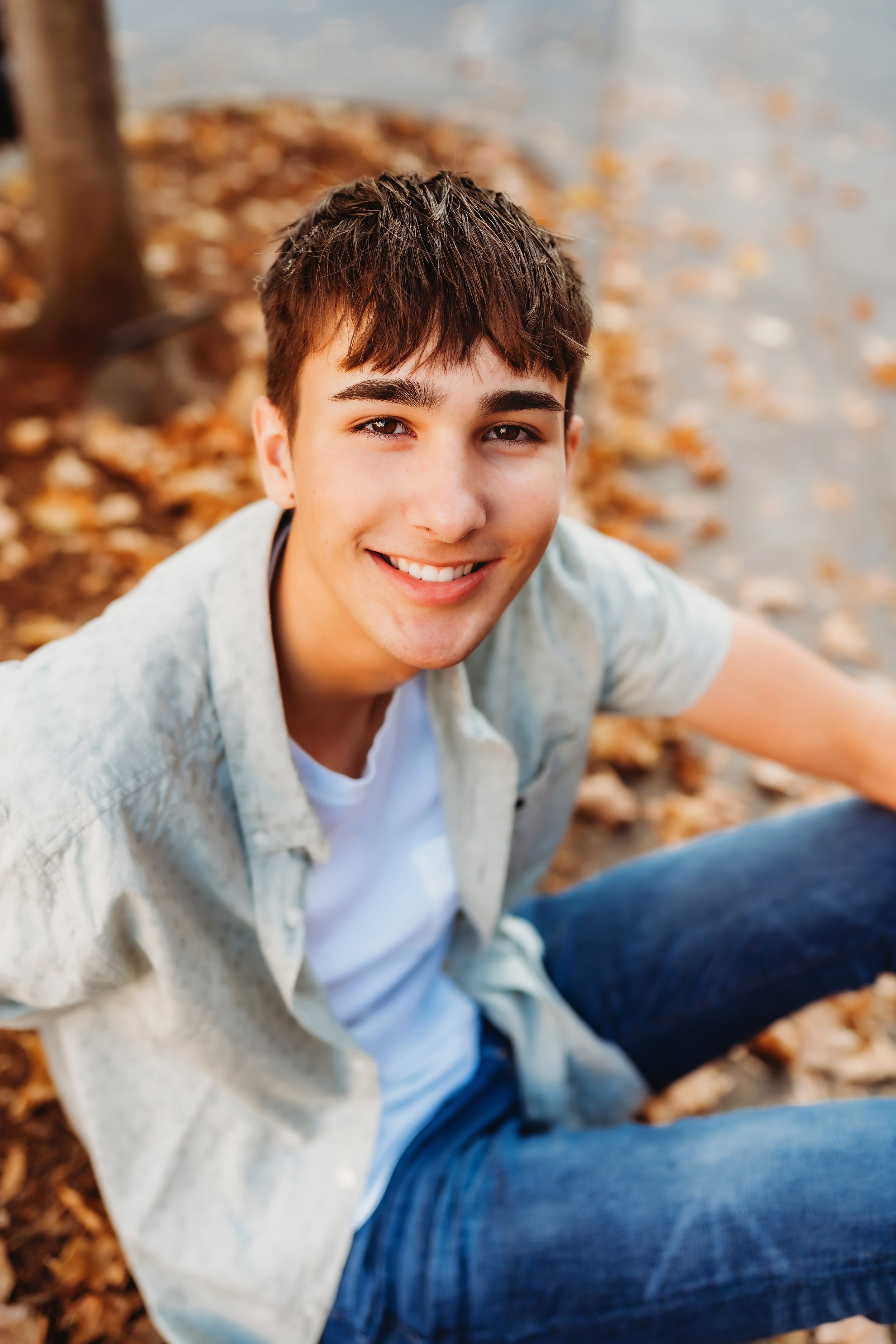 senior boy sitting looking up at camera