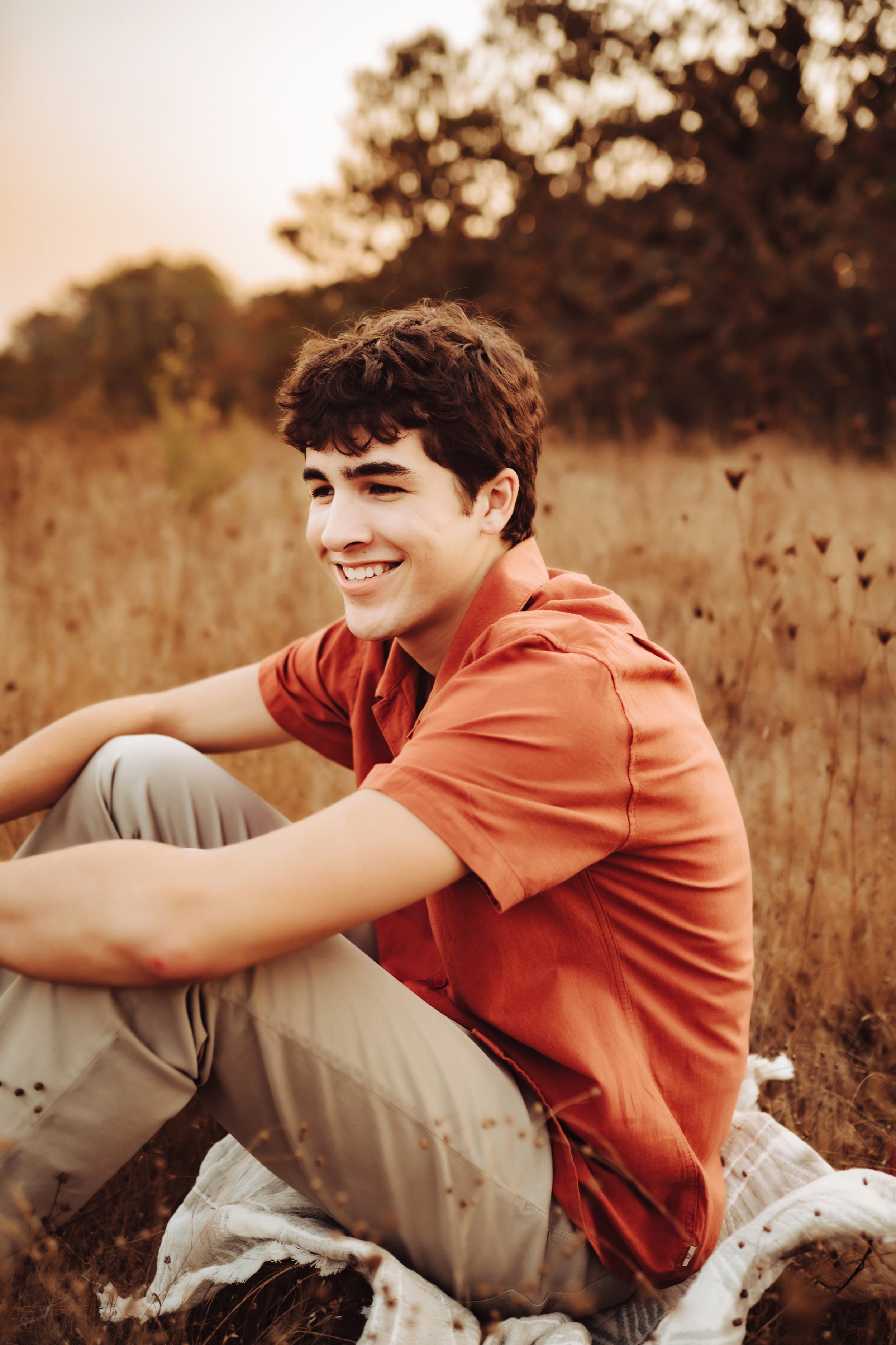 Senior boy sitting and laughing