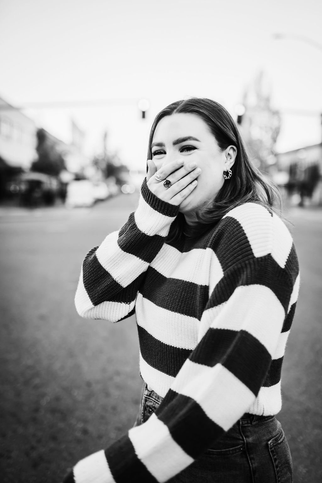 Senior girl waking across street laughing