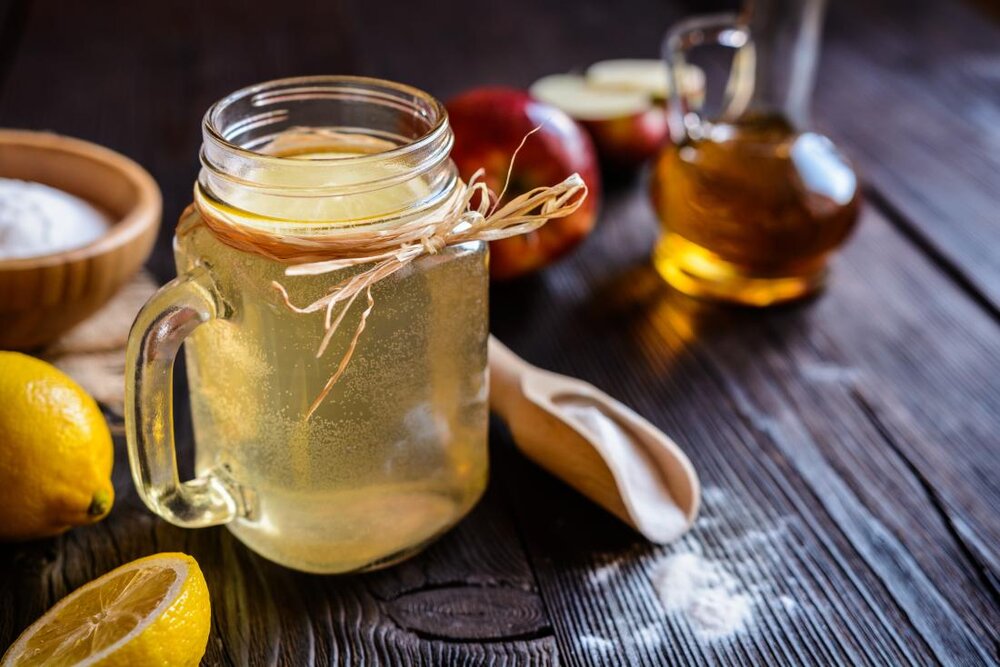 apple-cider-vinegar-used-to-make-detox-drink-with-lemon-juice-and-sugar-in-glass-mason-jar.jpg