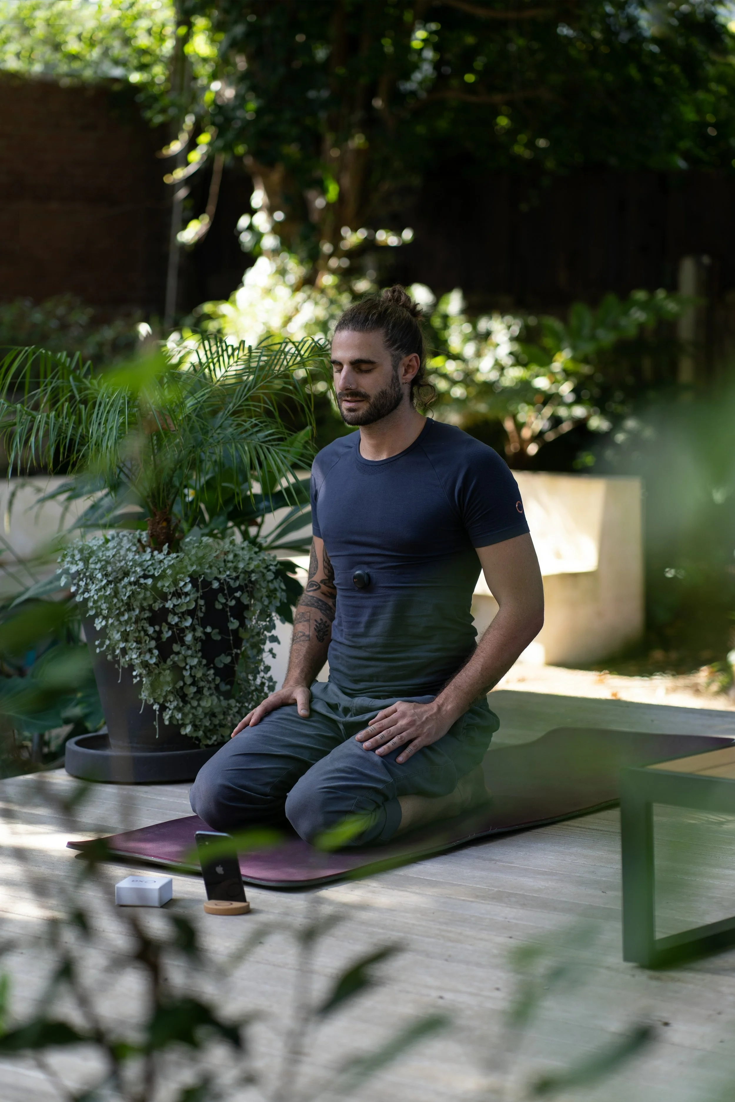 man using his phone to do virtual breathwork