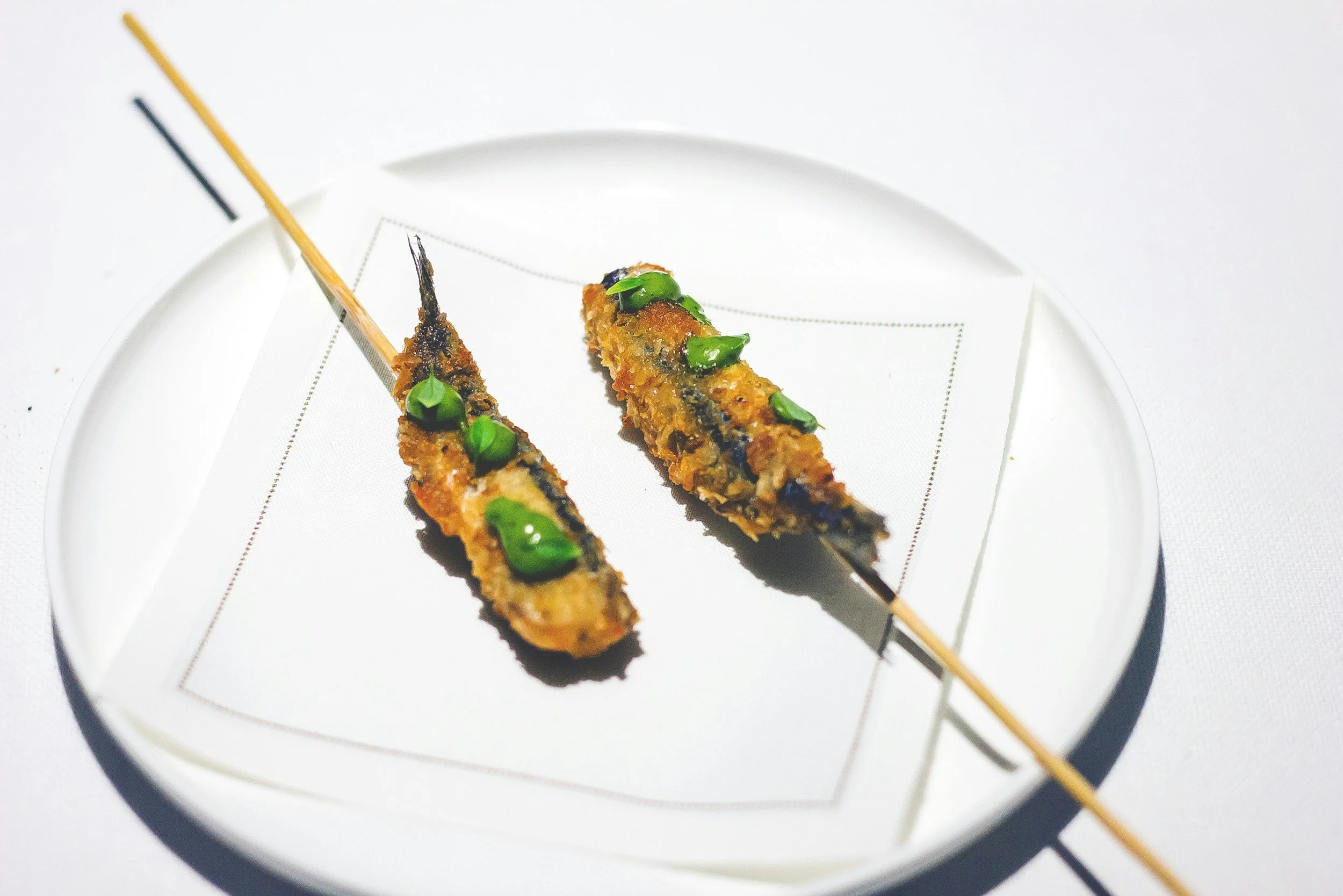 Fried sardines on a stick