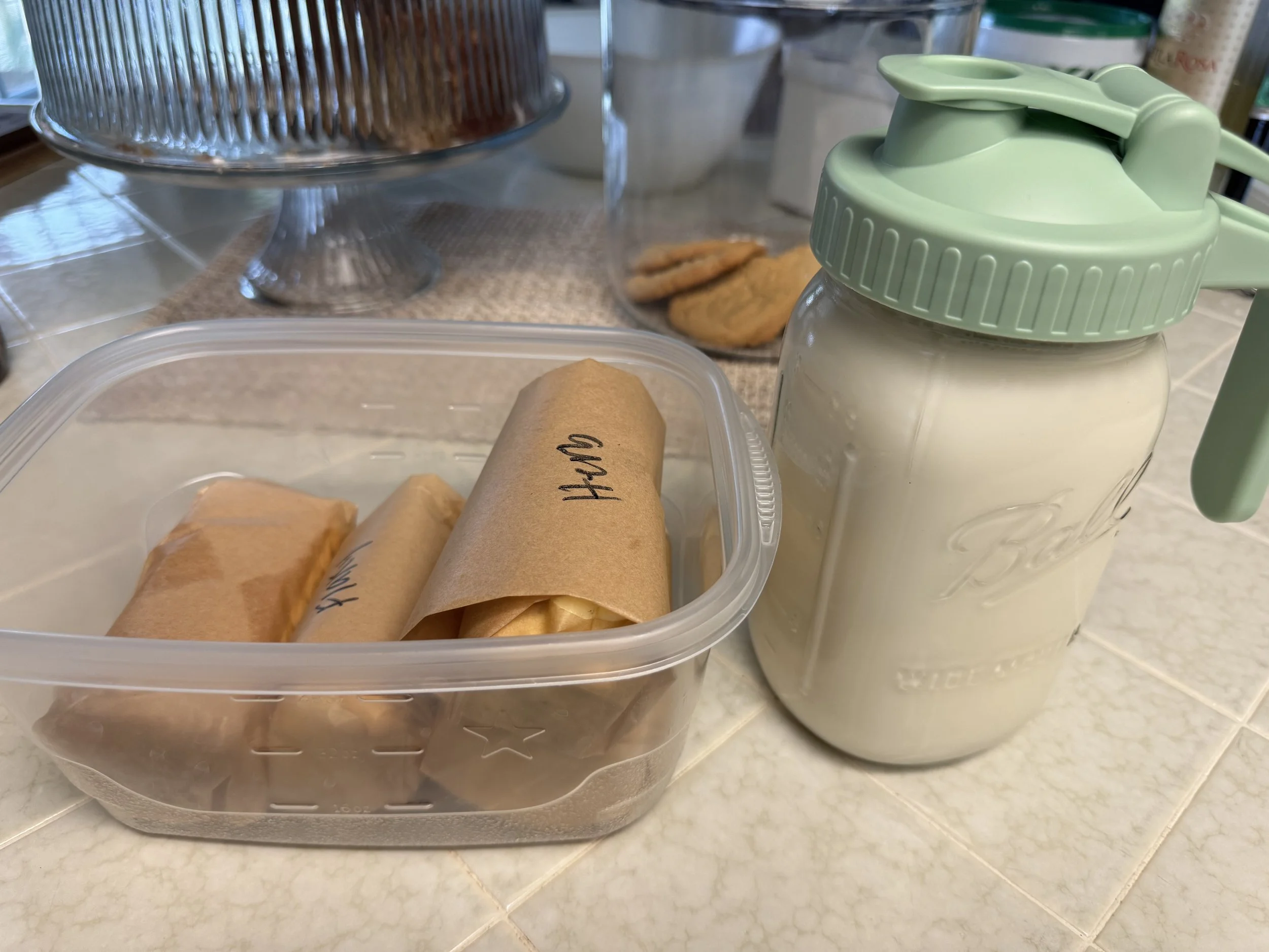 Butter rolled into parchment paper and a jar of buttermilk